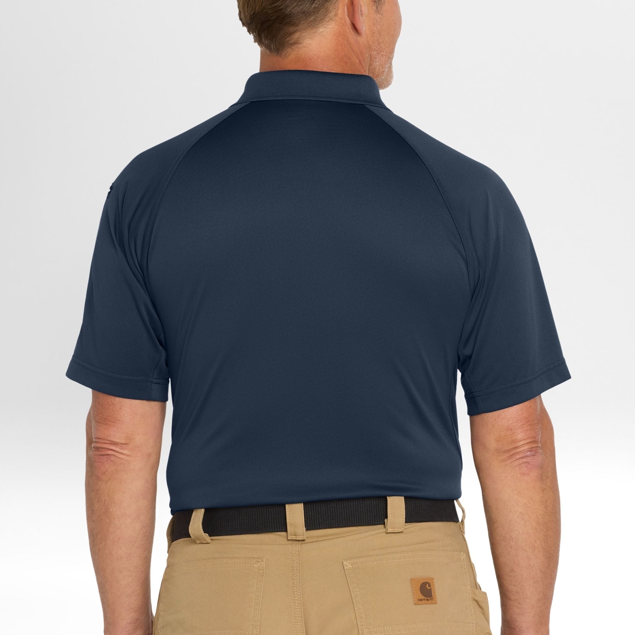 Man wearing a navy blue Snag-Proof Tactical Polo shirt and beige pants on a white background