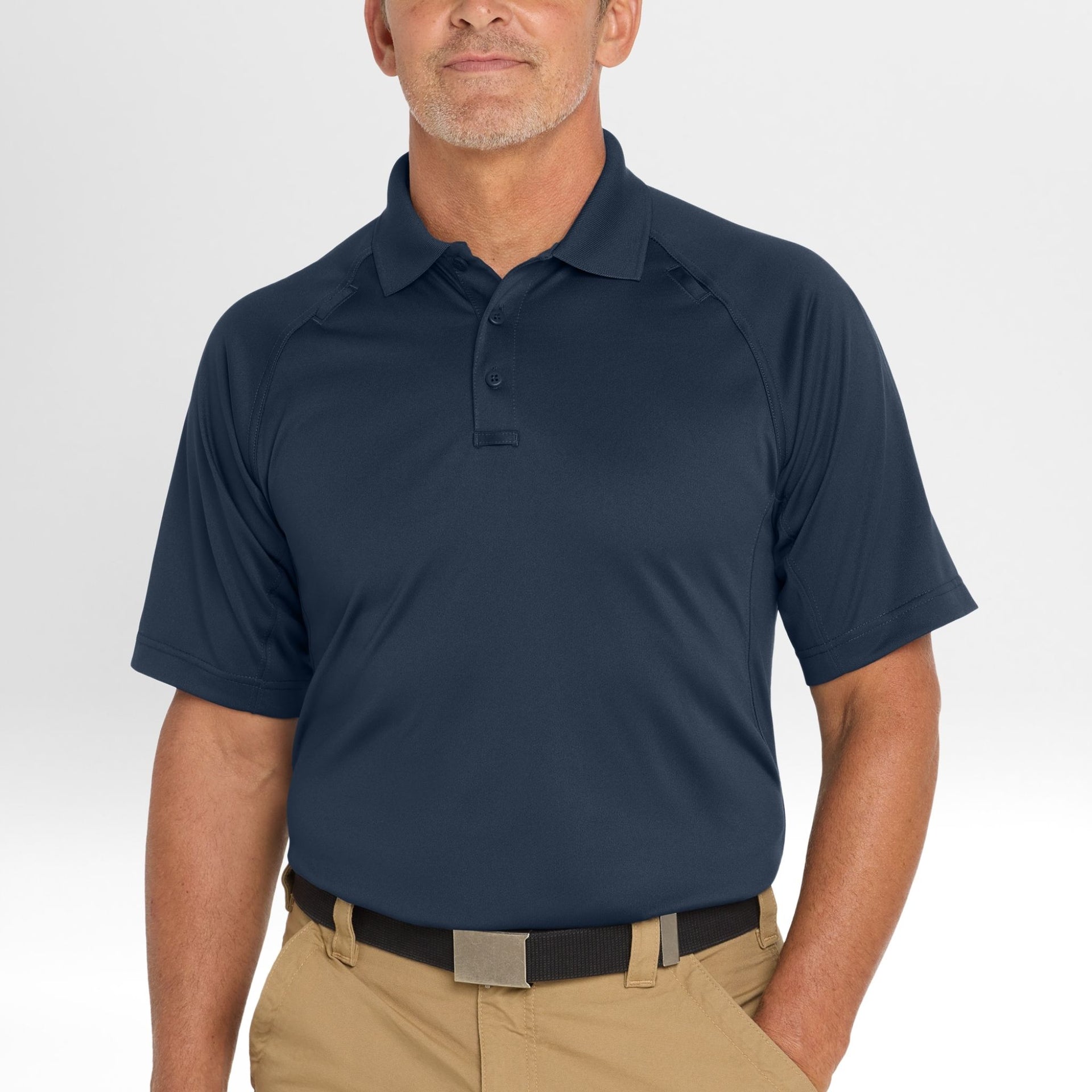 Man wearing a navy blue Snag-Proof Tactical Polo shirt on a white background