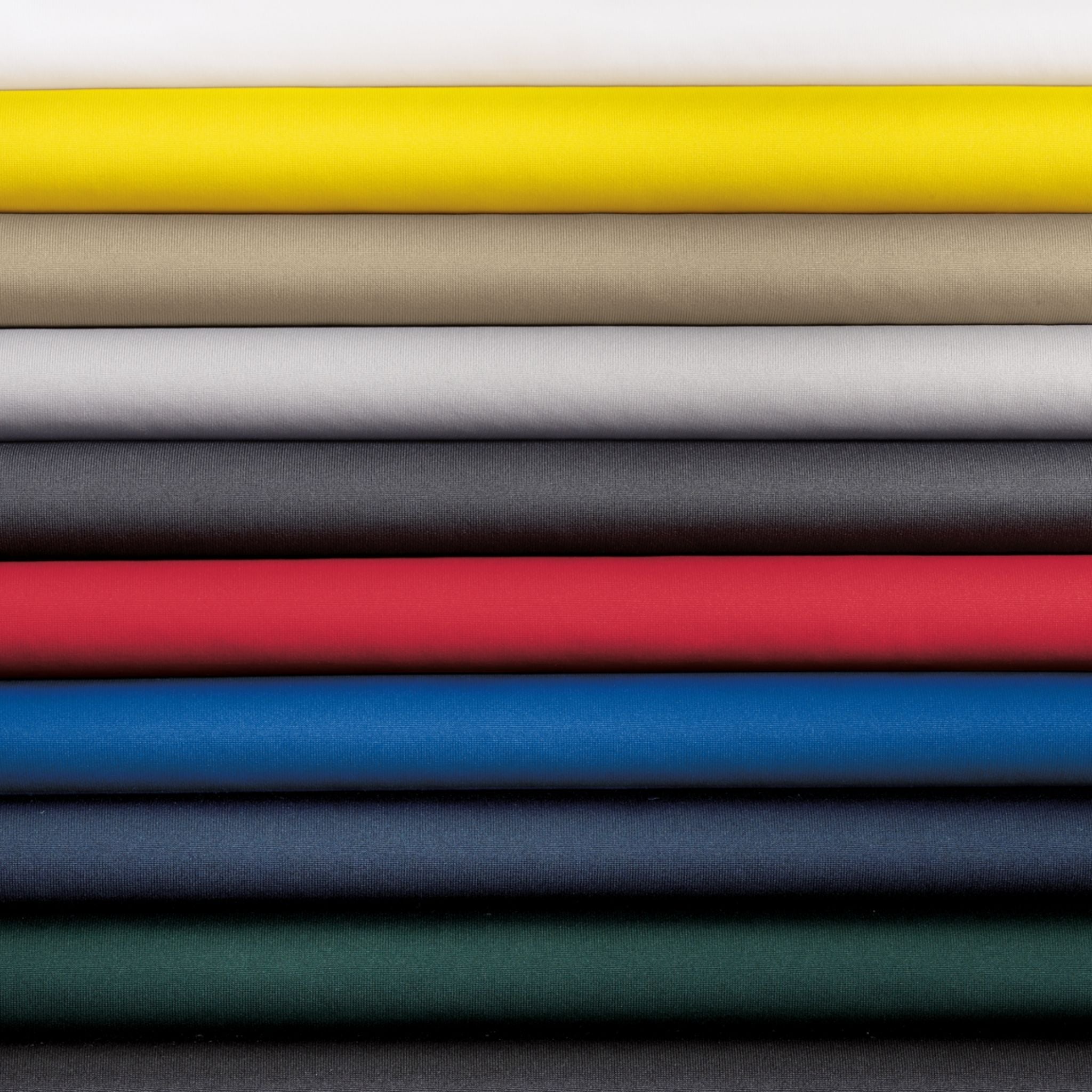 Stack of folded fabric swatches in various colors
