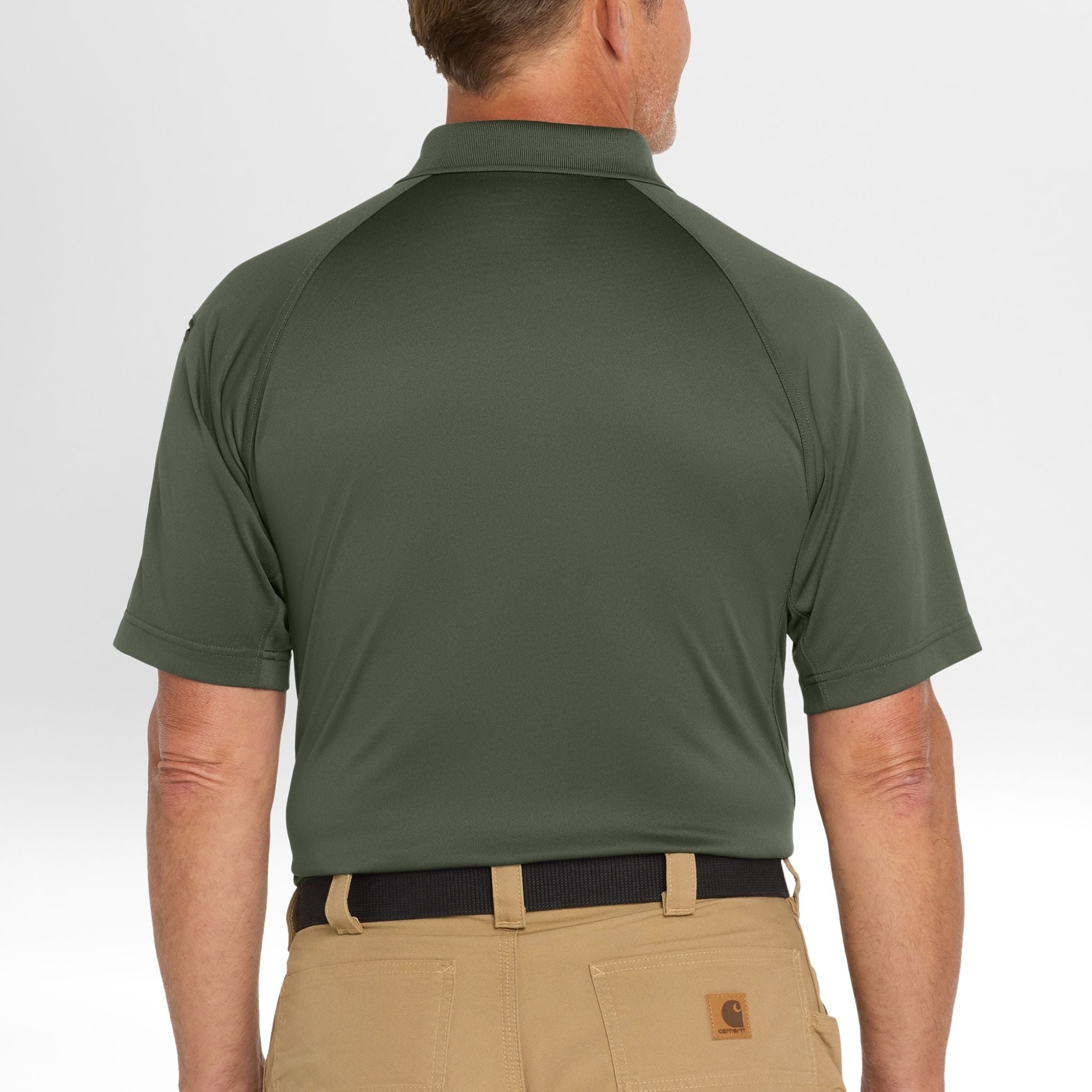 Person wearing a green Snag-Proof Tactical Polo shirt and beige pants on a white background