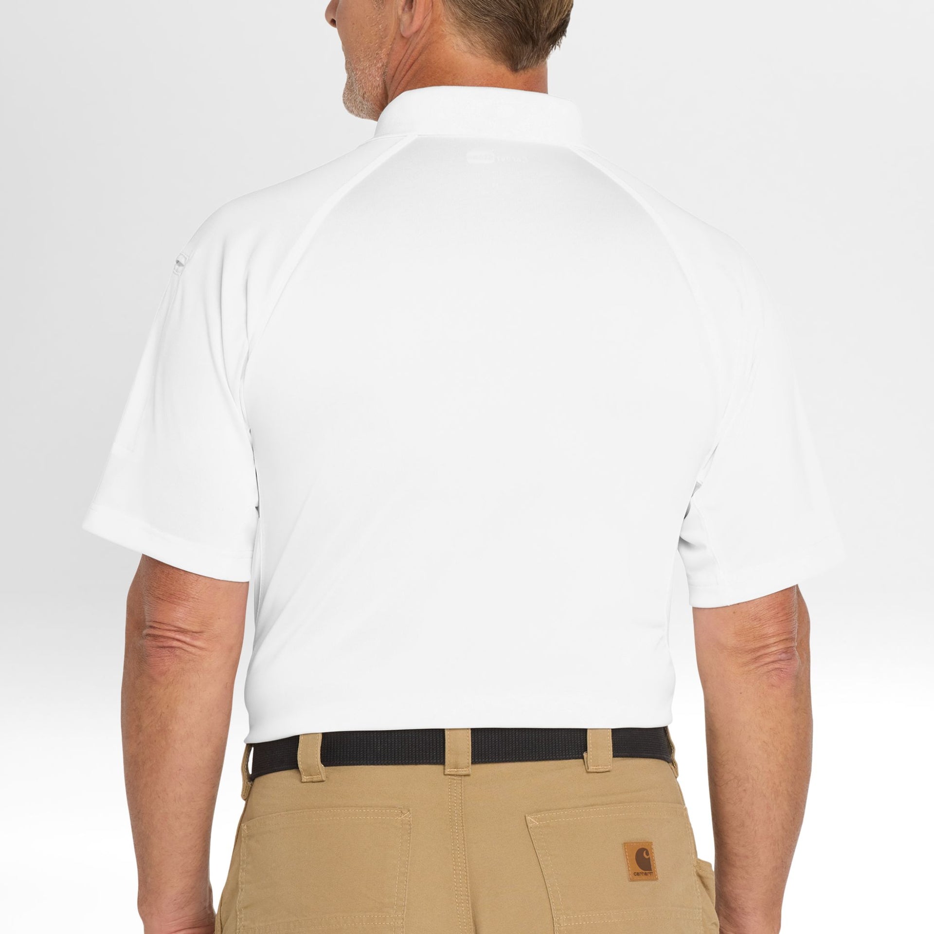 Person wearing a white Snag-Proof Tactical Polo shirt and beige pants on a plain background