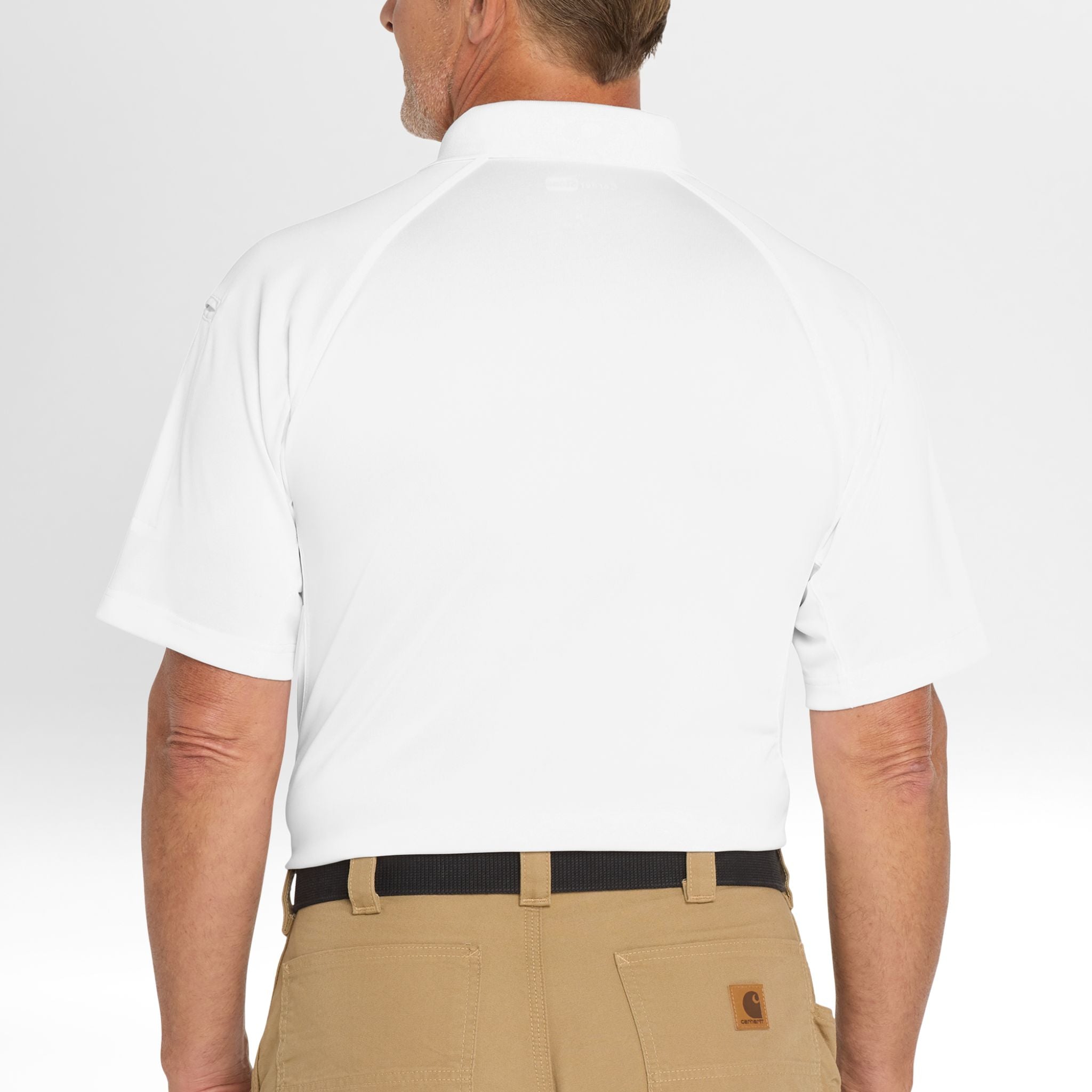Person wearing a white Snag-Proof Tactical Polo shirt and beige pants on a plain background