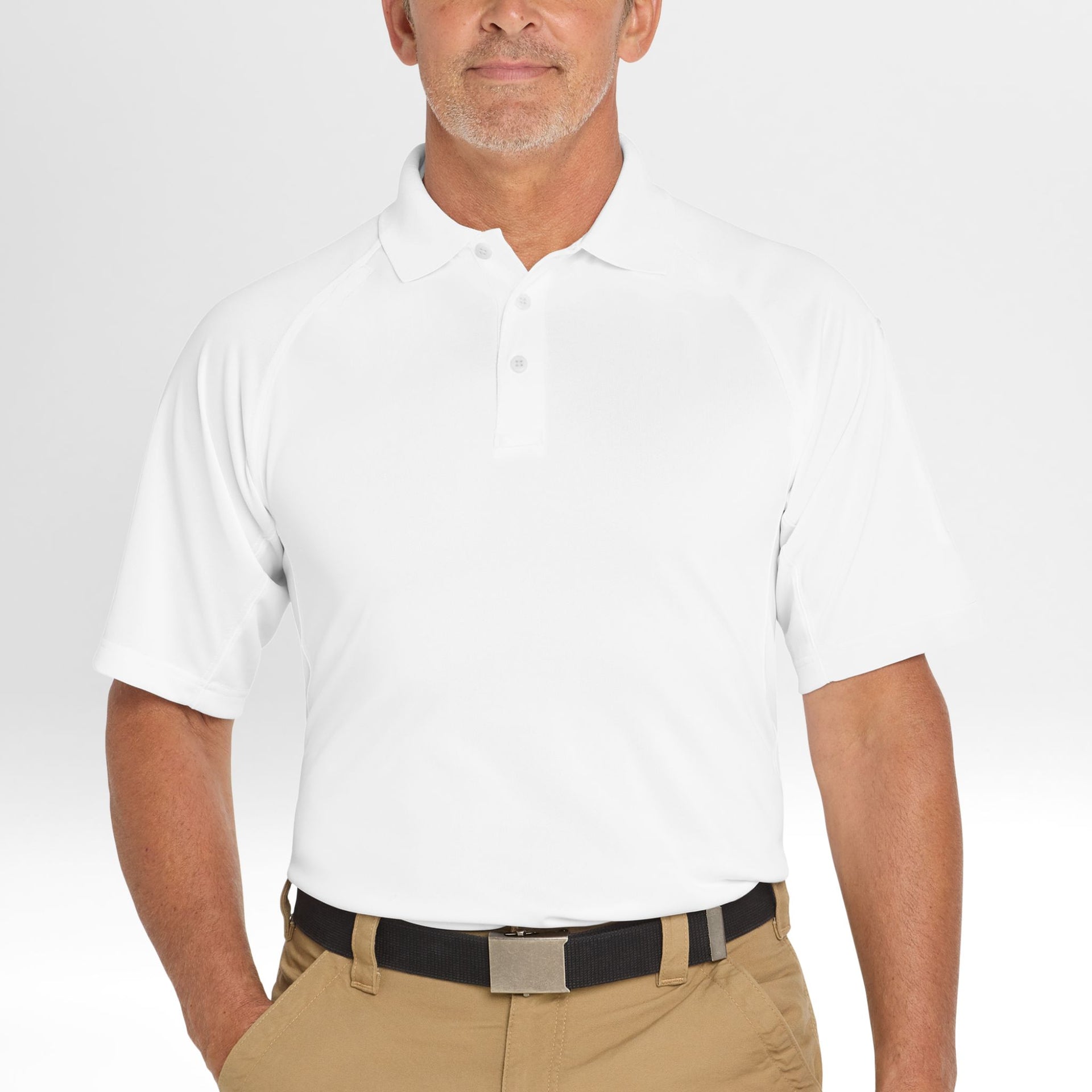 Man wearing a white Snag-Proof Tactical Polo shirt and beige pants on a plain background
