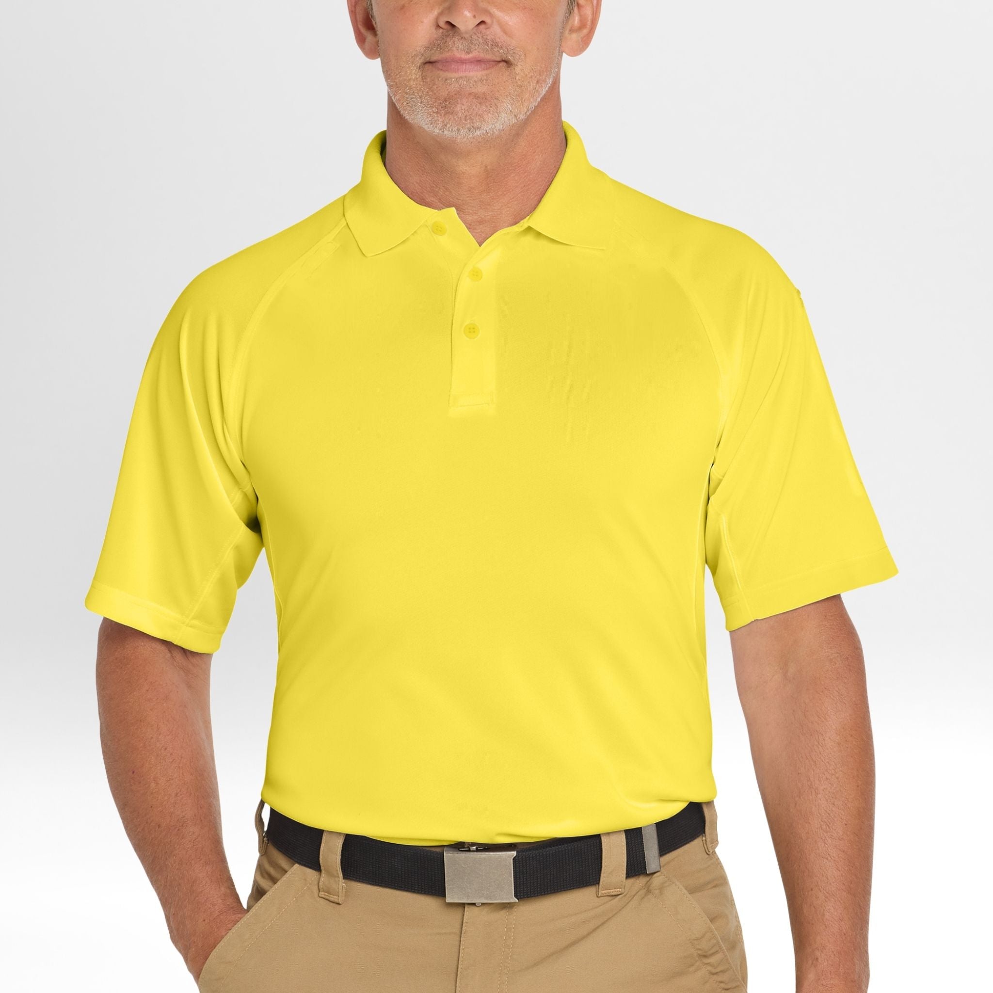 Man wearing a bright yellow Snag-Proof Tactical Polo shirt on a plain background