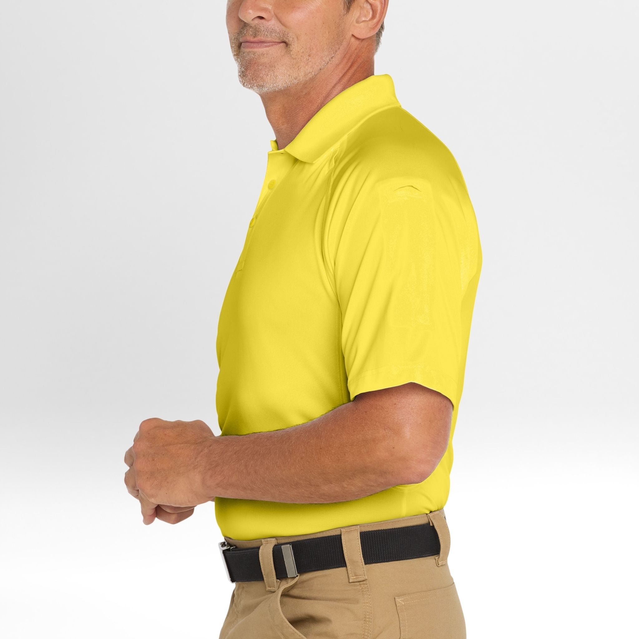 Man wearing a bright yellow Snag-Proof Tactical Polo shirt on a light gray background