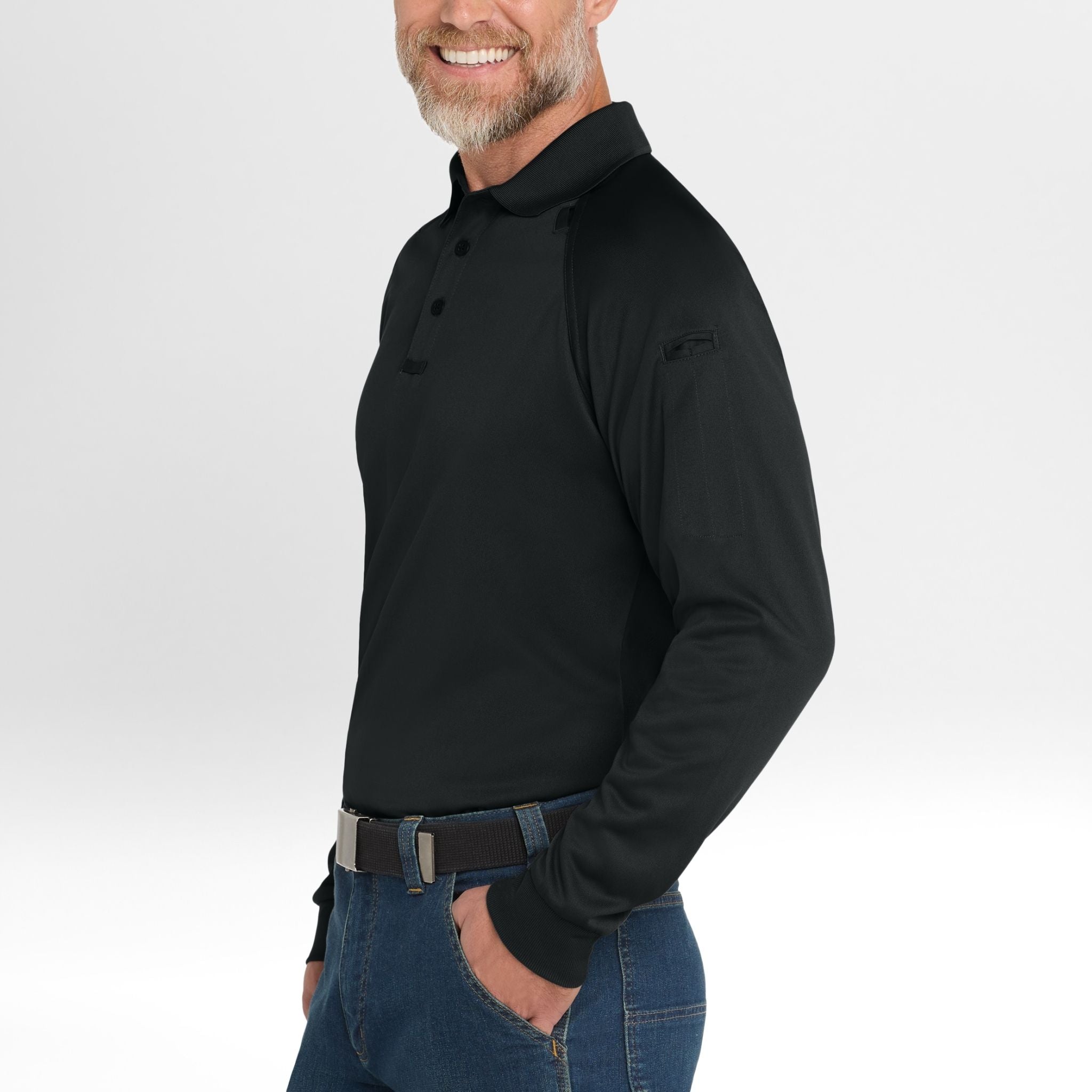 Man wearing a black long-sleeve Snag-Proof Tactical Polo shirt and blue jeans on a white background