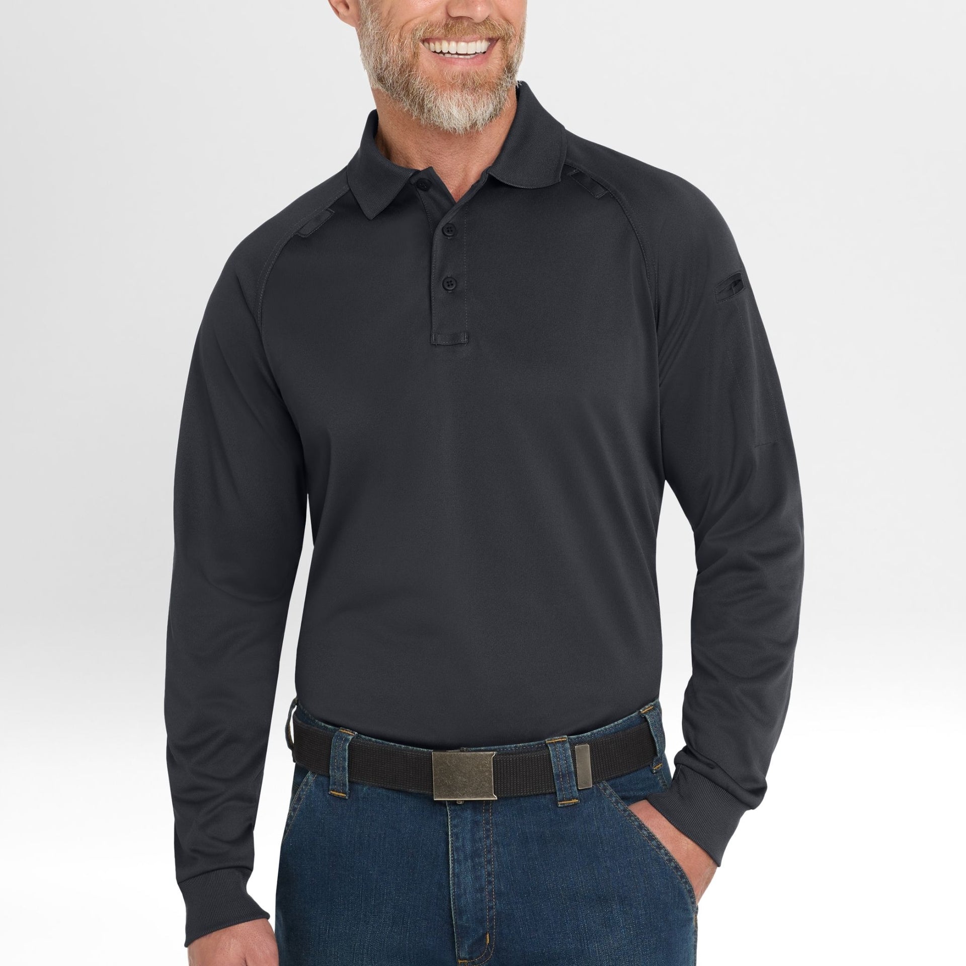Man wearing a black long-sleeve Snag-Proof Tactical Polo shirt and blue jeans on a white background