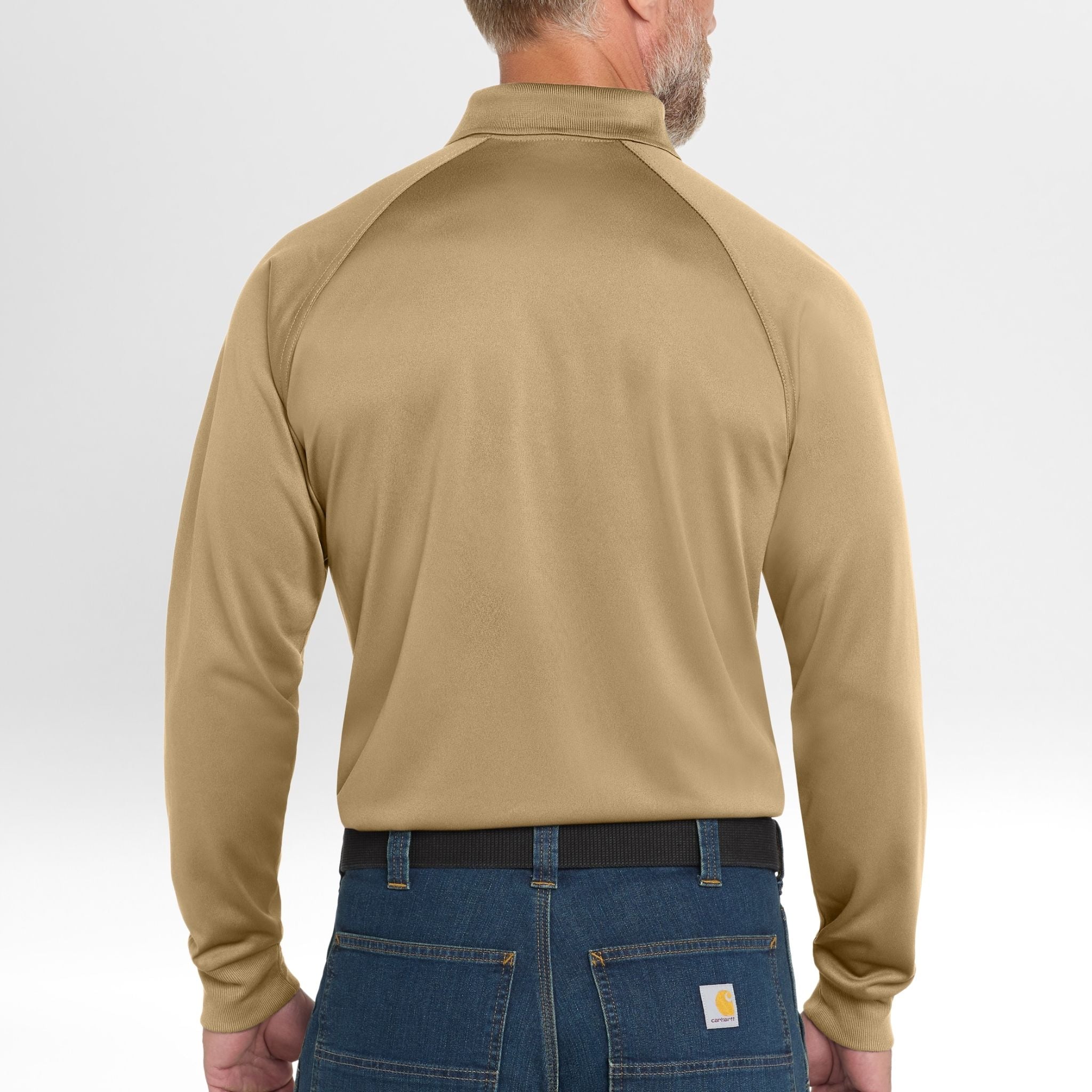 Man wearing a beige long-sleeve Snag-Proof Tactical Polo shirt and blue jeans on a white background