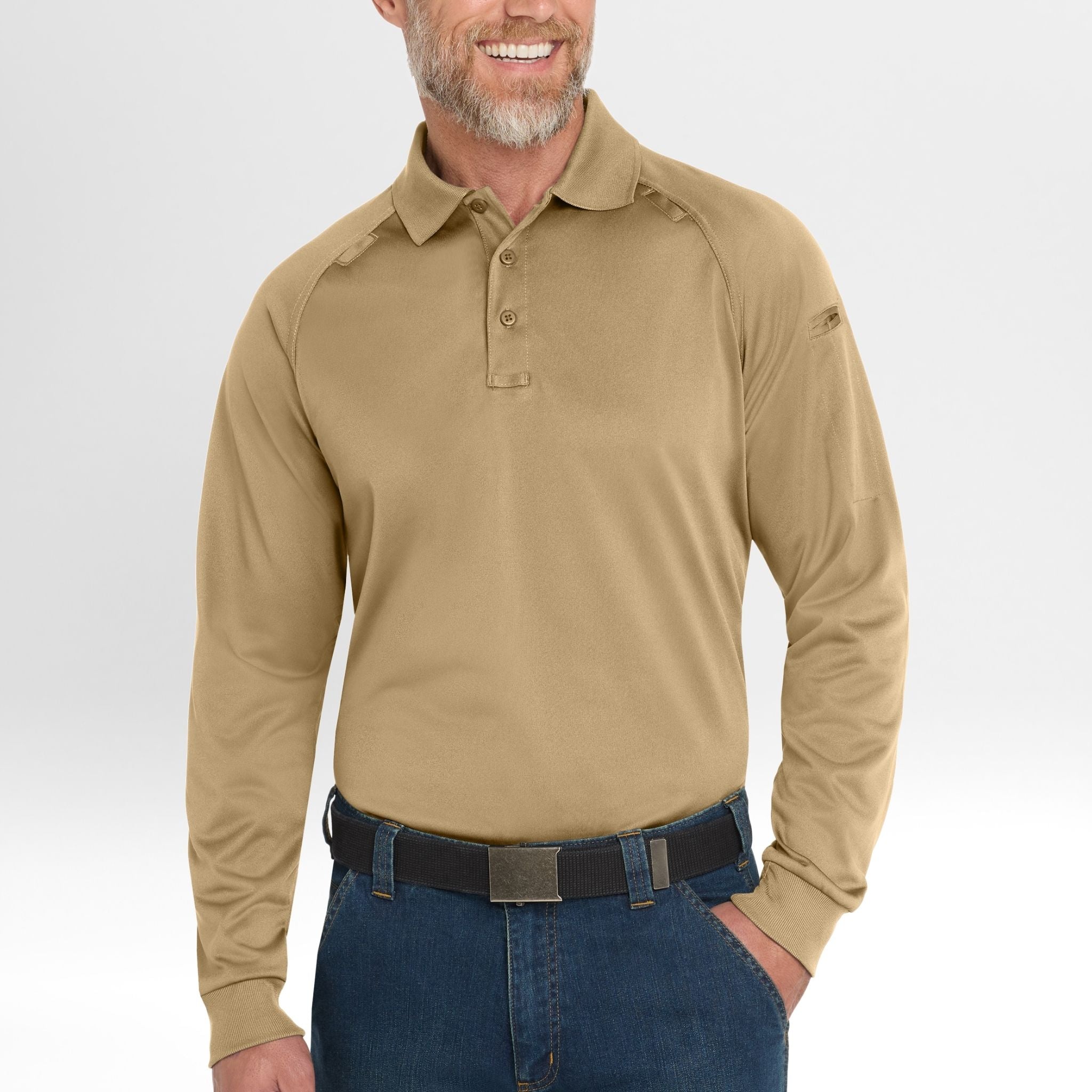 Man wearing a beige long-sleeve Snag-Proof Tactical Polo shirt and blue jeans on a white background