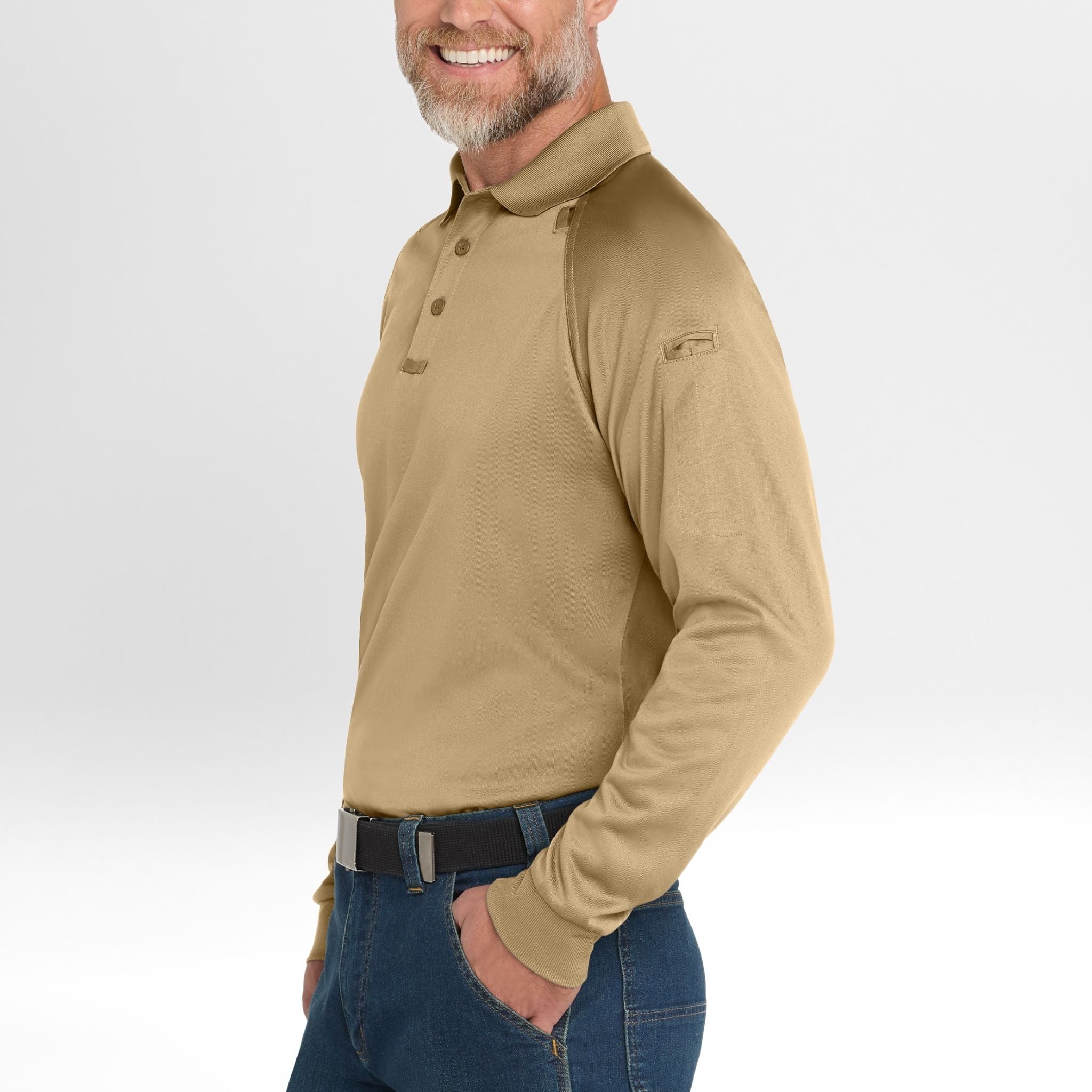 Man wearing a beige long-sleeve Snag-Proof Tactical Polo shirt and blue jeans on a white background