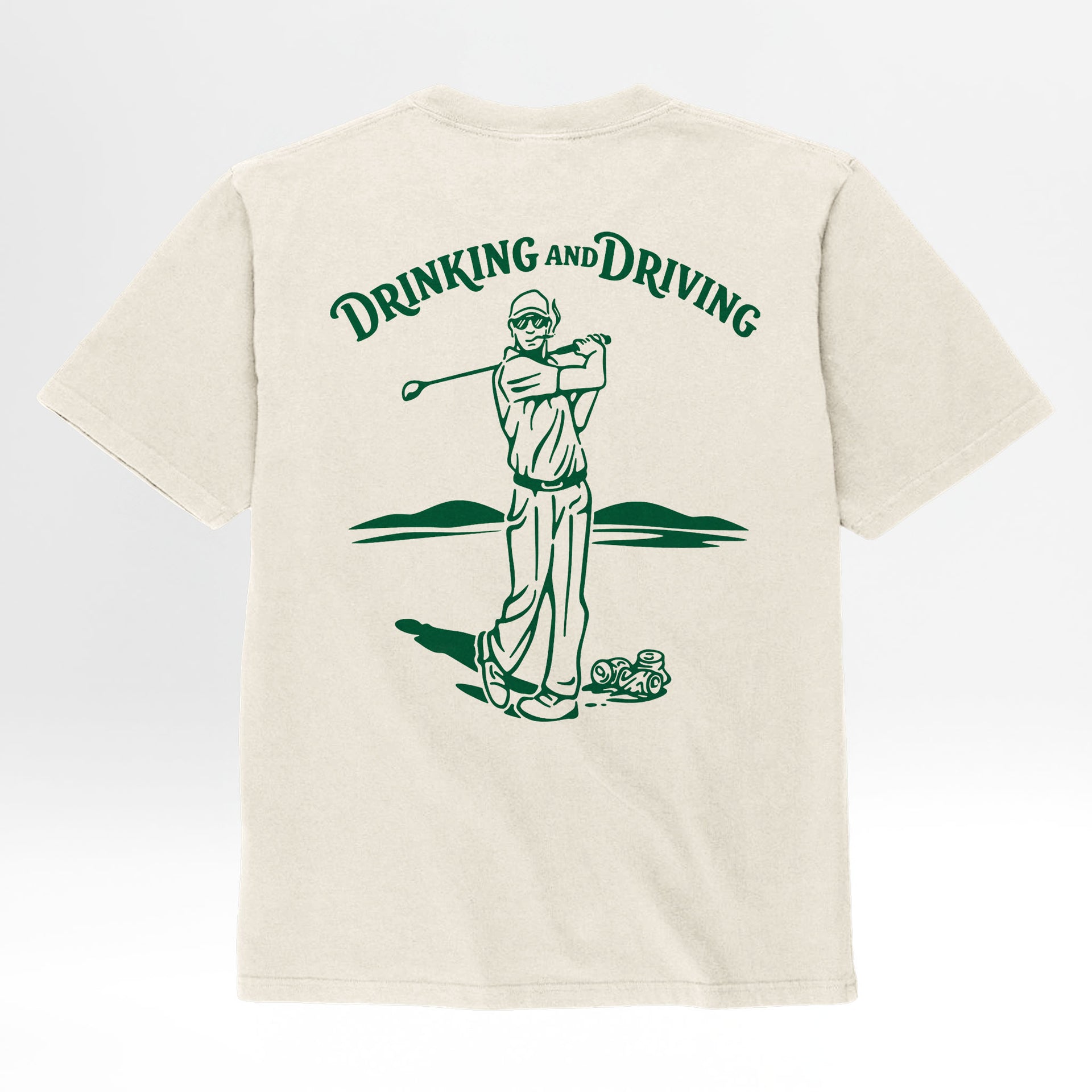 Beige t-shirt with a graphic of a person drinking from a bottle and driving a golf cart, with 'Drinking and Driving' text.