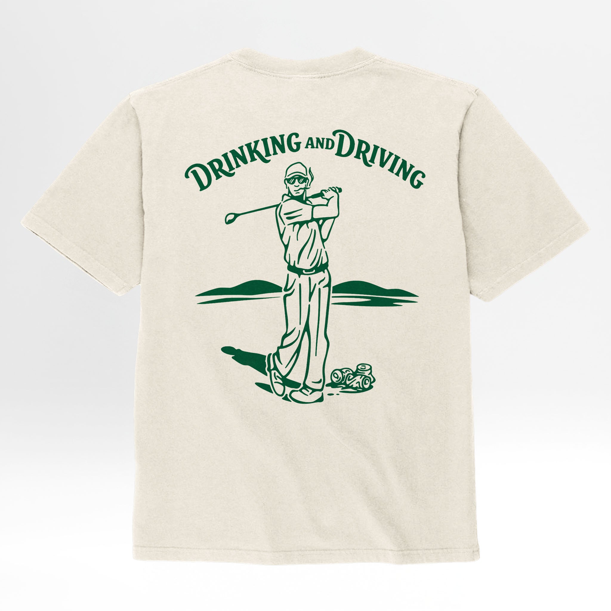 Beige t-shirt with a graphic of a person drinking from a bottle and driving a golf cart, with 'Drinking and Driving' text.