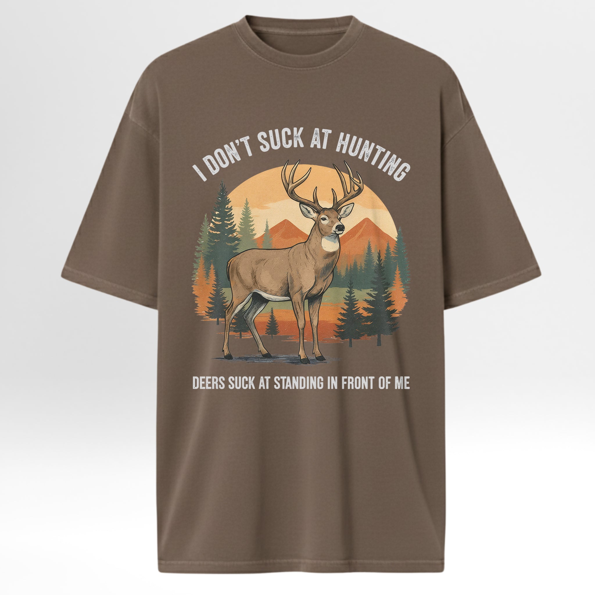 Brown hunting t-shirt with a graphic of a deer and text 'I Don't Suck At Hunting Deers Suck At Standing In Front Of Me'.