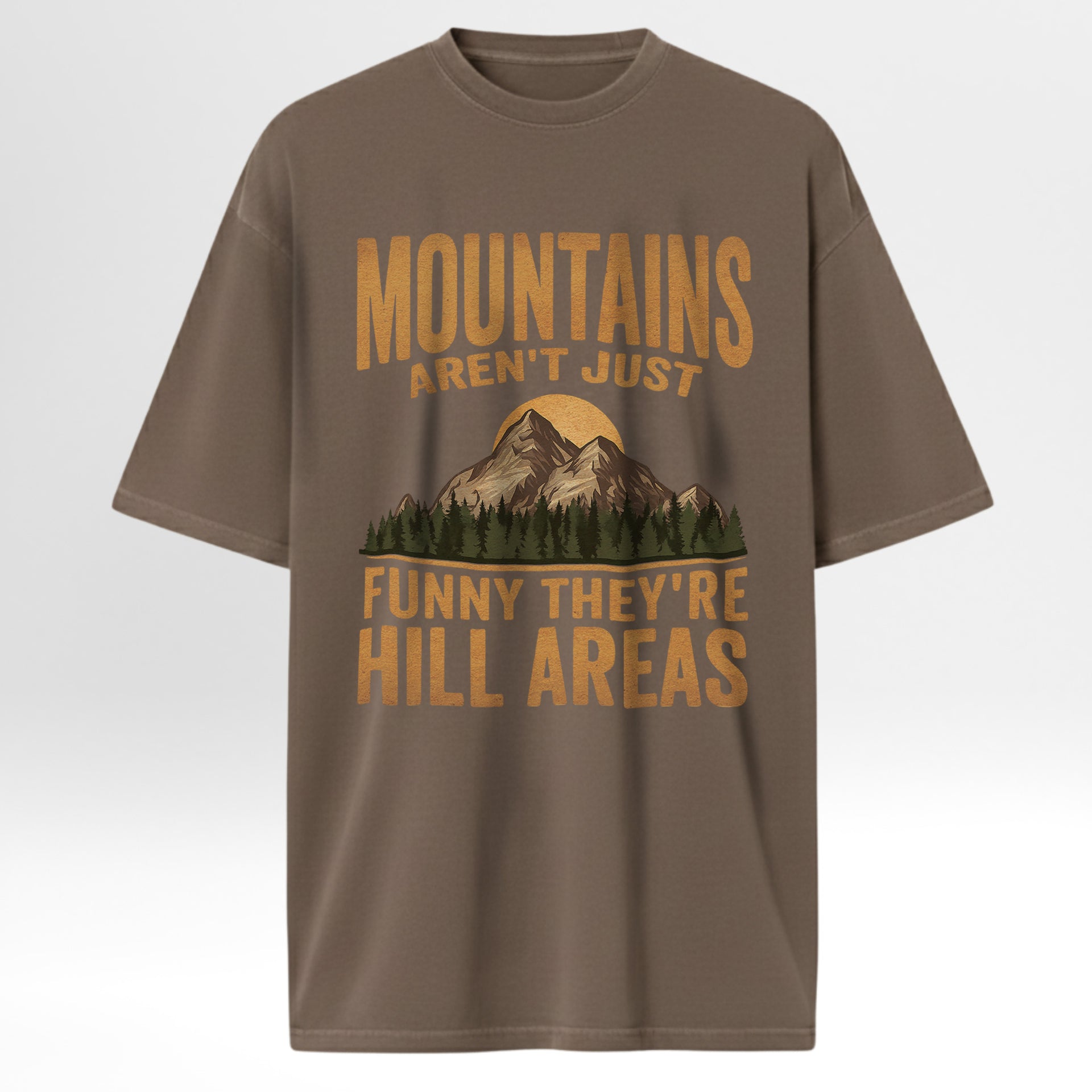 Brown t-shirt with mountain graphic and humorous text 'Mountains Aren't Just Funny They're Hill Areas'