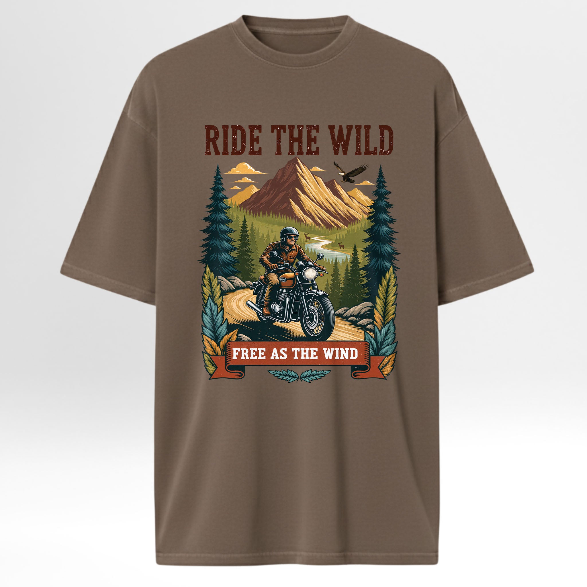 Brown trail graphic t-shirt with a graphic of a person on a motorcycle in a forest and text 'Ride the Wild, Free as the Wind' on a white background.
