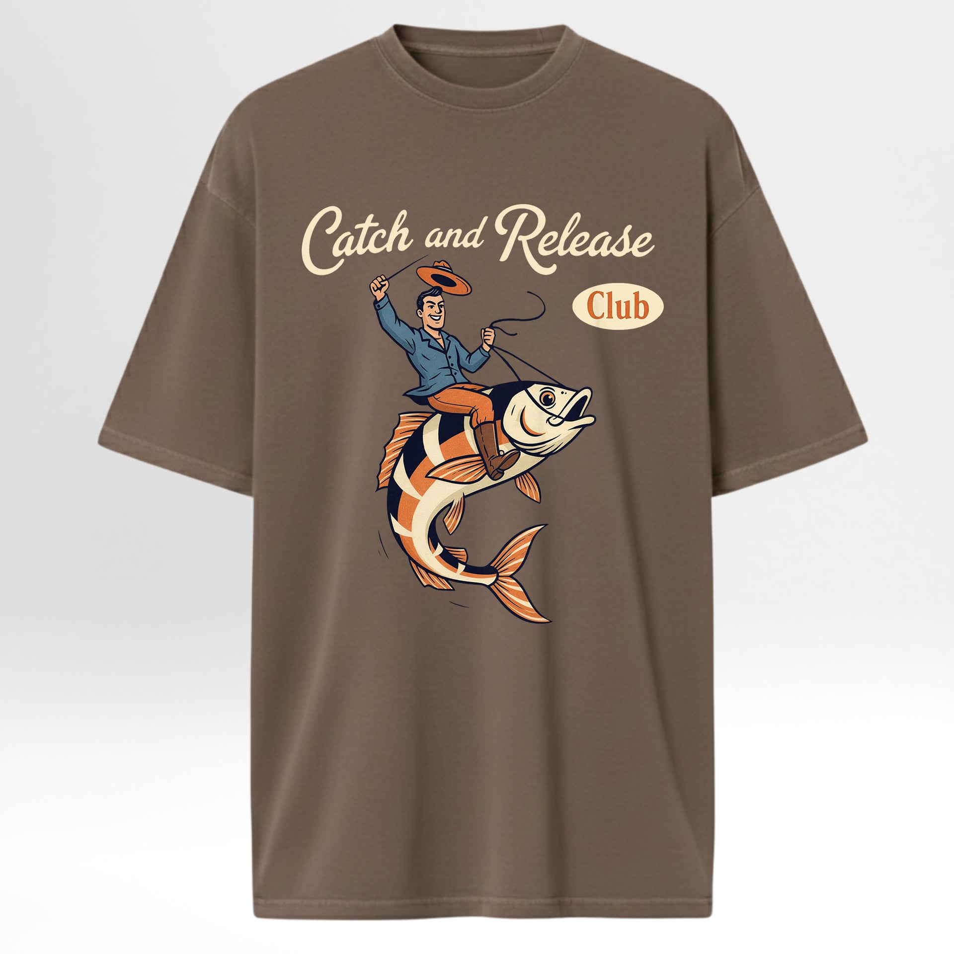 Brown fishing t-shirt with a graphic of a man on a fish and 'Catch and Release Club' text.