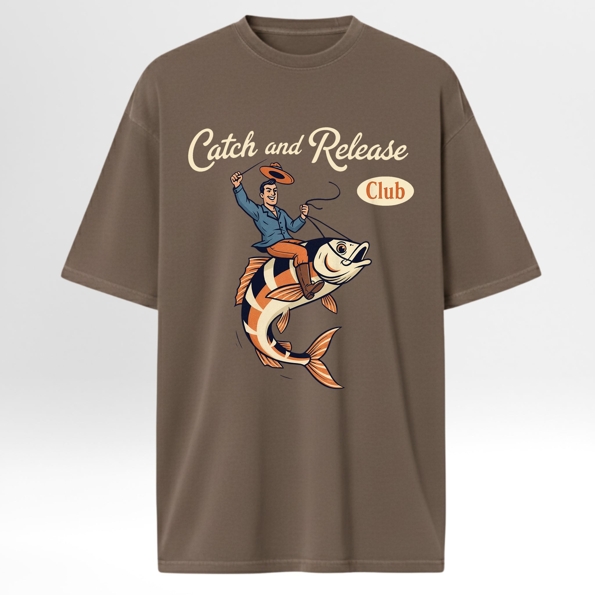 Brown fishing t-shirt with a graphic of a man on a fish and 'Catch and Release Club' text.