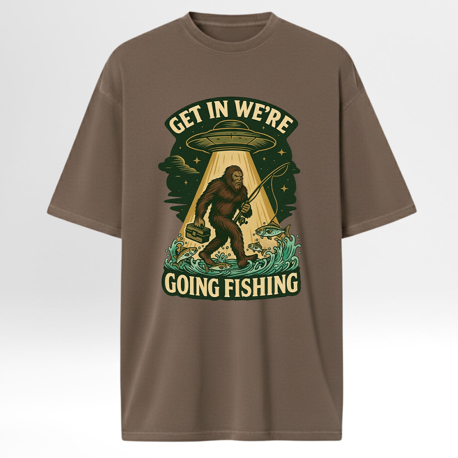 Brown fishing t-shirt with a graphic design featuring a Sasquatch, UFO, and text 'Get In We're Going Fishing'