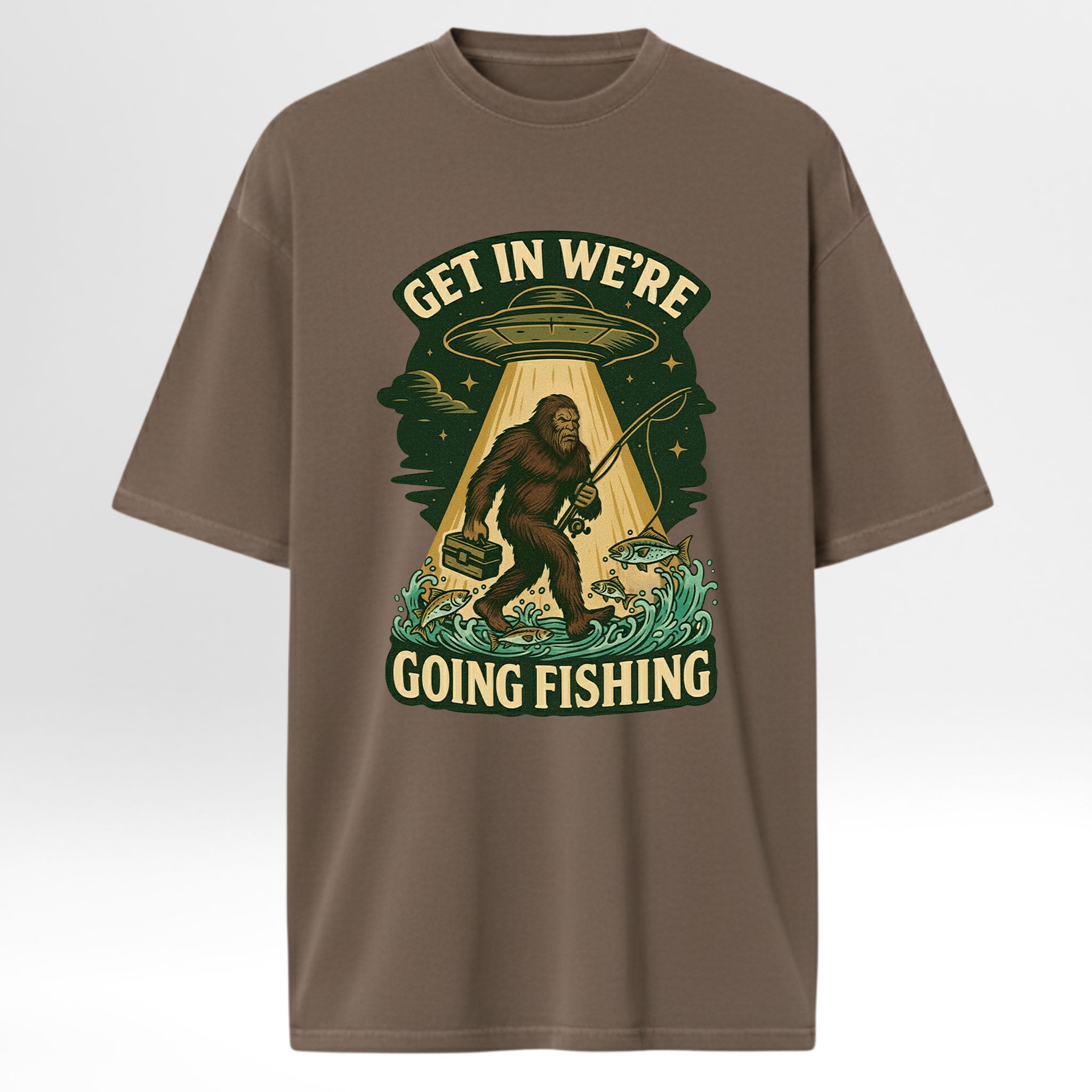 Brown fishing t-shirt with a graphic design featuring a Sasquatch, UFO, and text 'Get In We're Going Fishing'