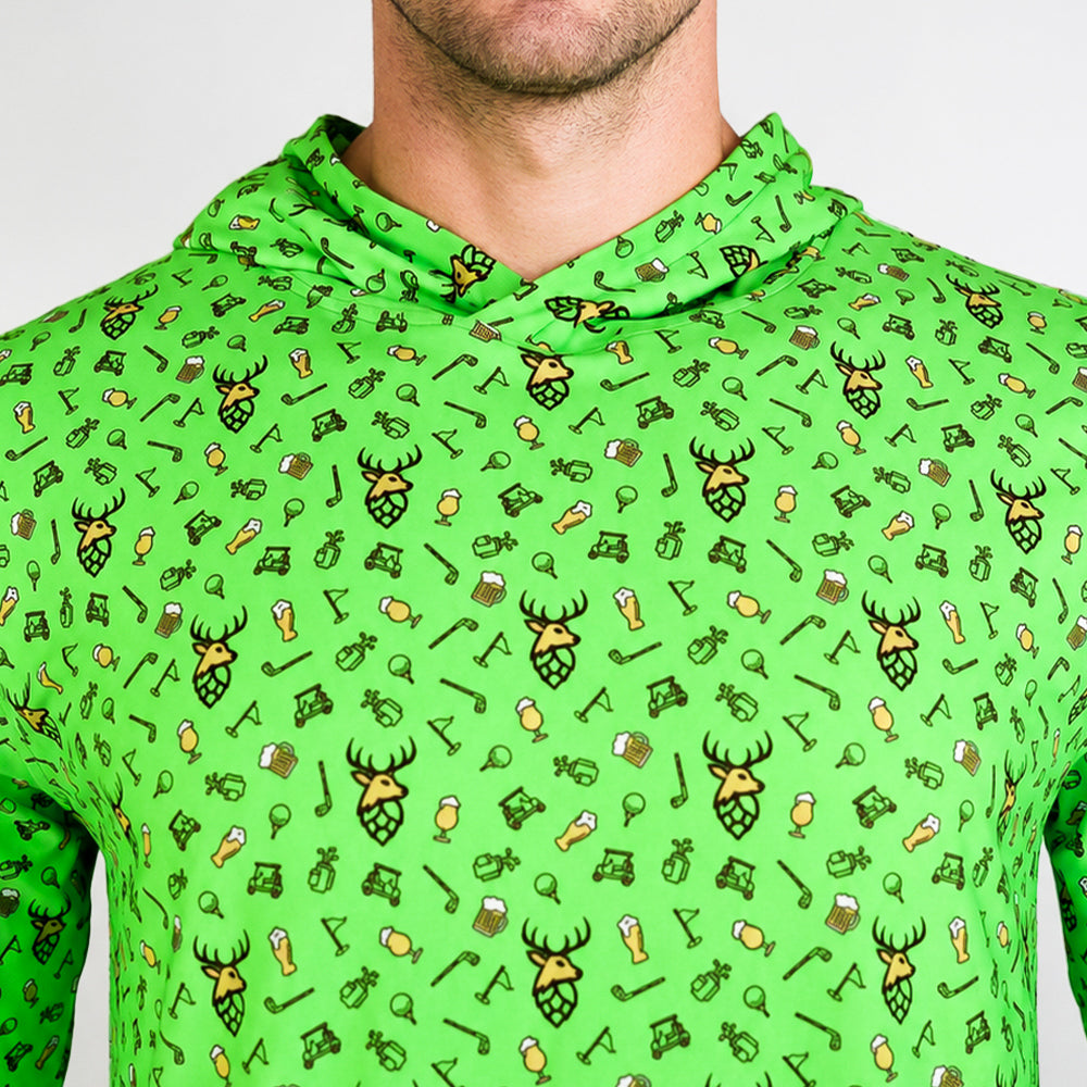 A close-up of a bright green hooded shirt with an all-over repeating print of beer-themed icons, including beer mugs, hops hopper heads, and beer glasses, worn by a model.