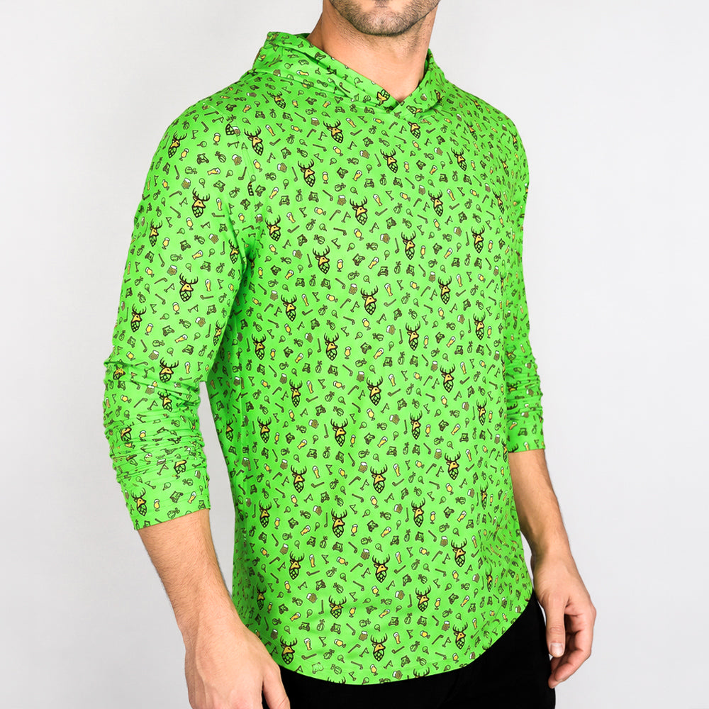 A man wearing a bright green long-sleeve hooded shirt with an all-over small graphic print, shown from the neck down against a plain light gray background.