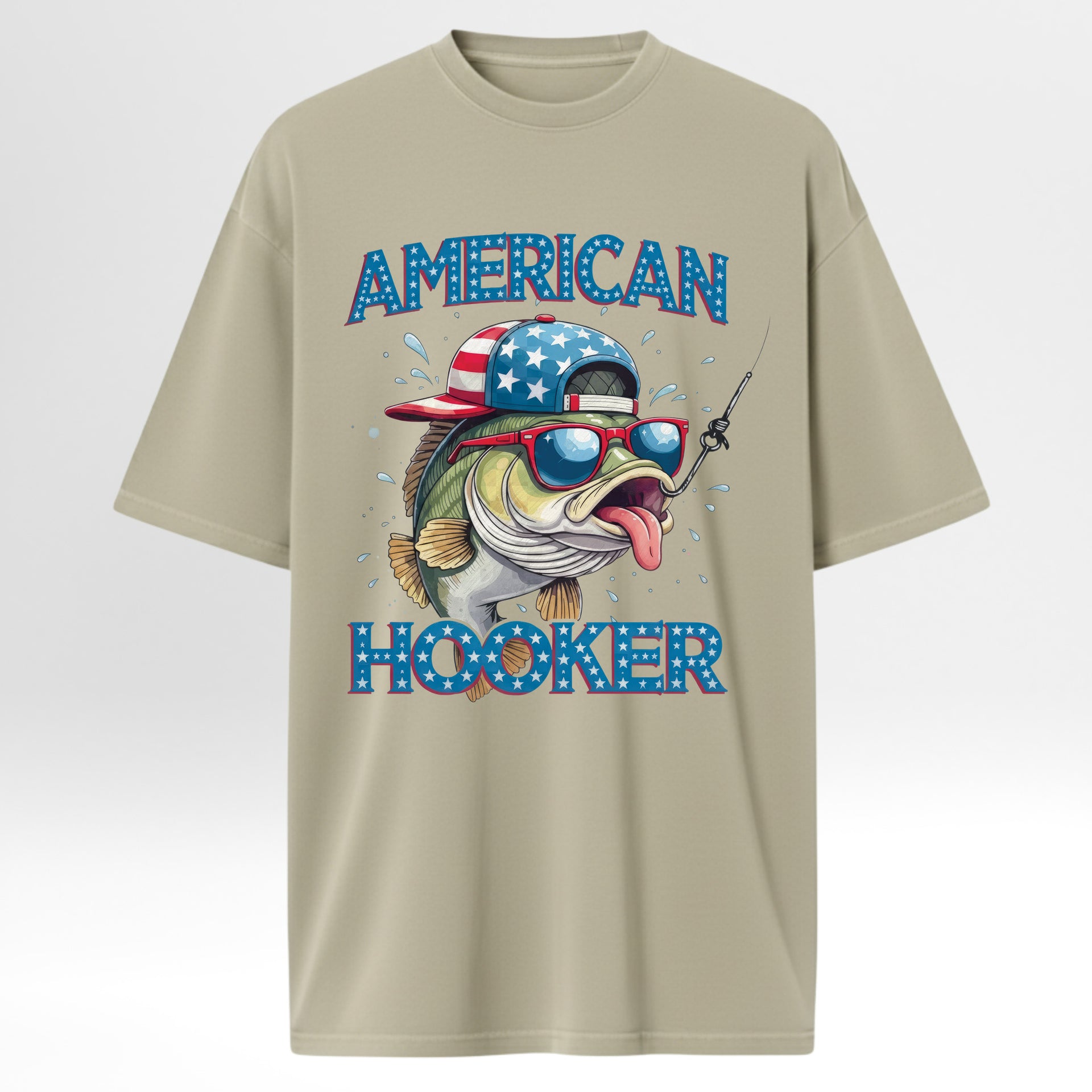 Beige fishing graphic t-shirt with a graphic of a fish wearing sunglasses and an American flag hat, with 'American Hooker' text.