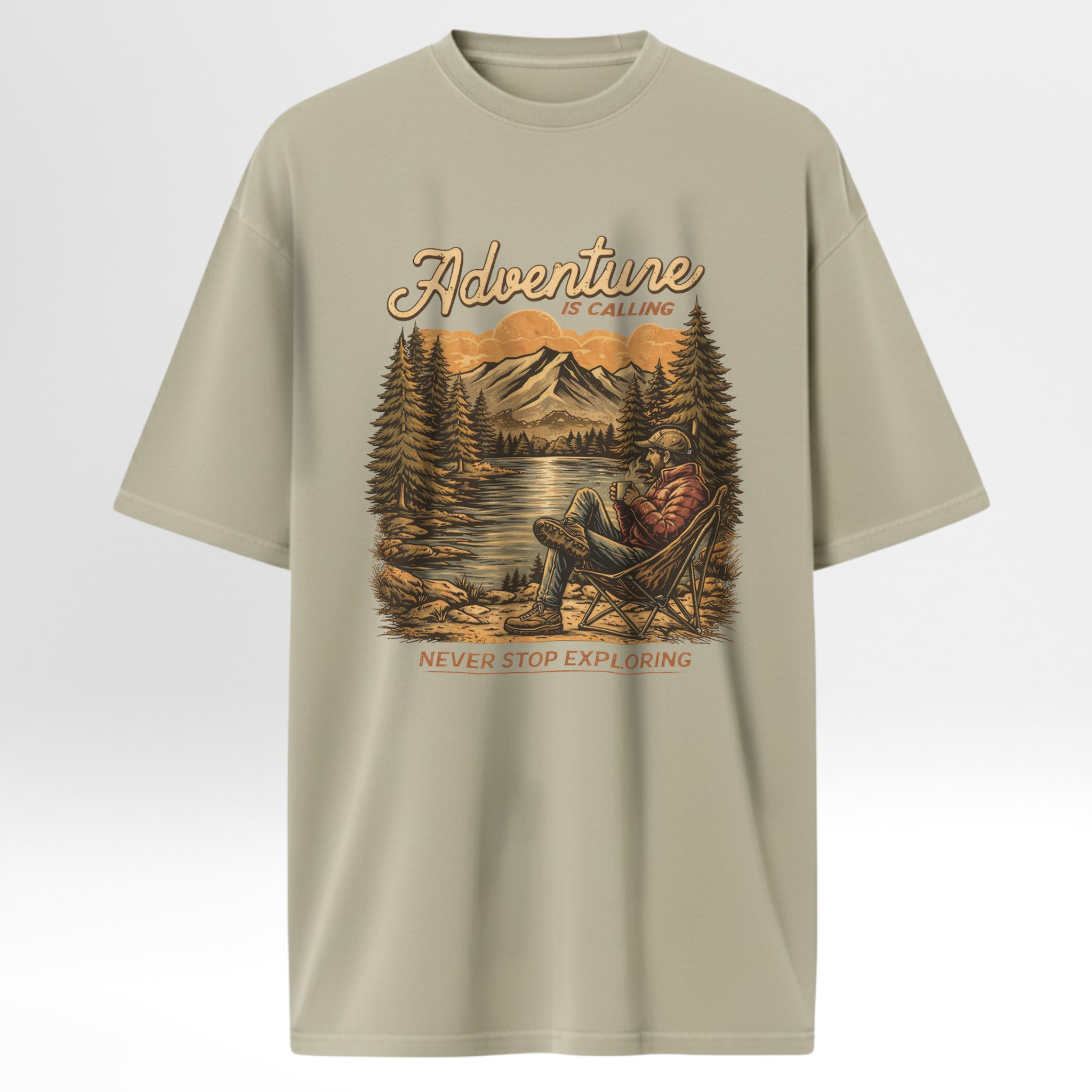 Beige t-shirt with a graphic of a person in a chair by a lake and mountains, with 'Adventure is Calling, Never Stop Exploring' text.