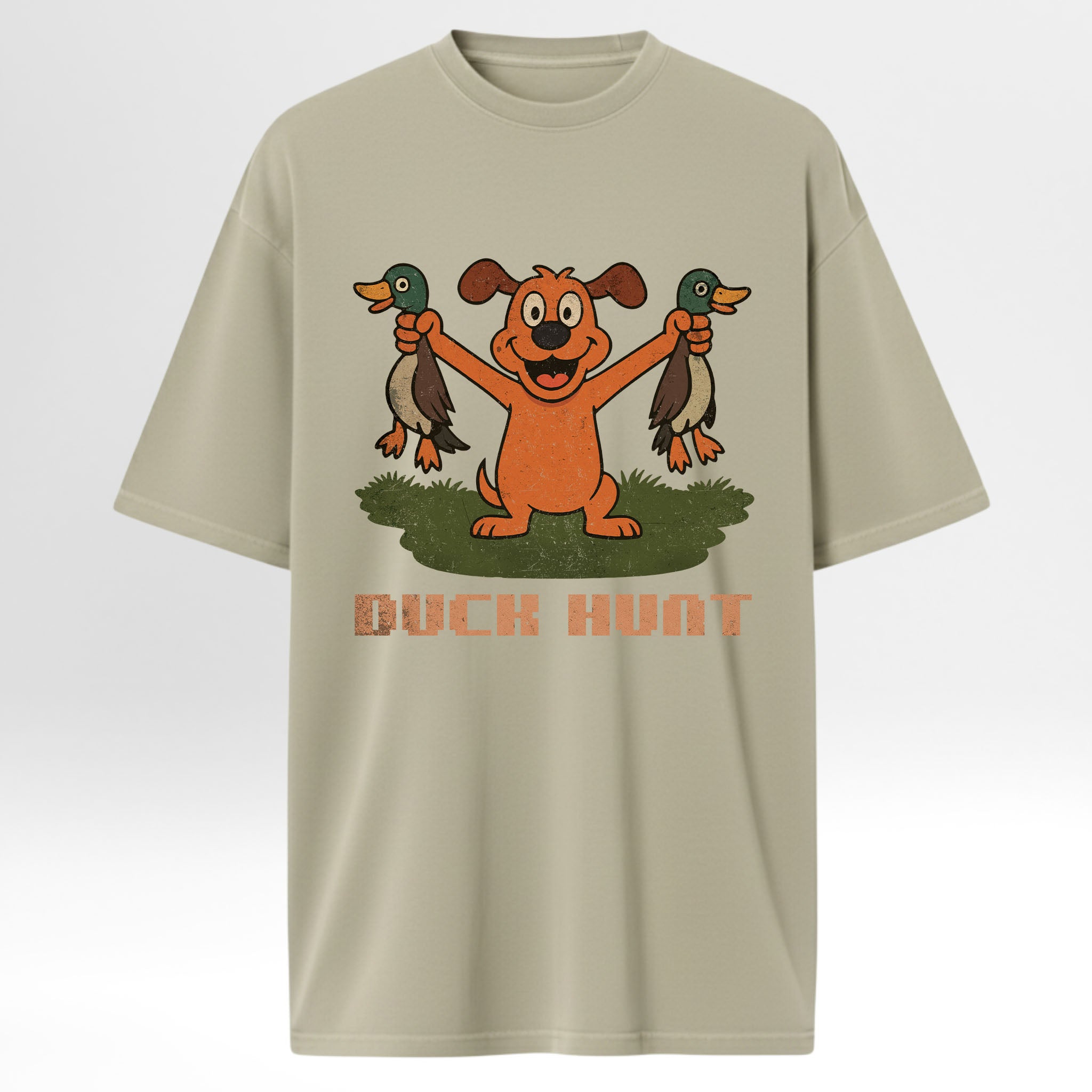 Beige hunting graphic t-shirt with a cartoon dog holding two ducks and 'Duck Hunt' text on a white background