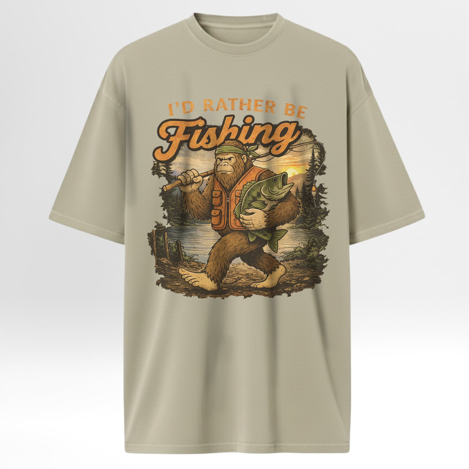 Beige fishing t-shirt with a graphic of a Bigfoot holding a fish and the text 'I'd Rather Be Fishing'.