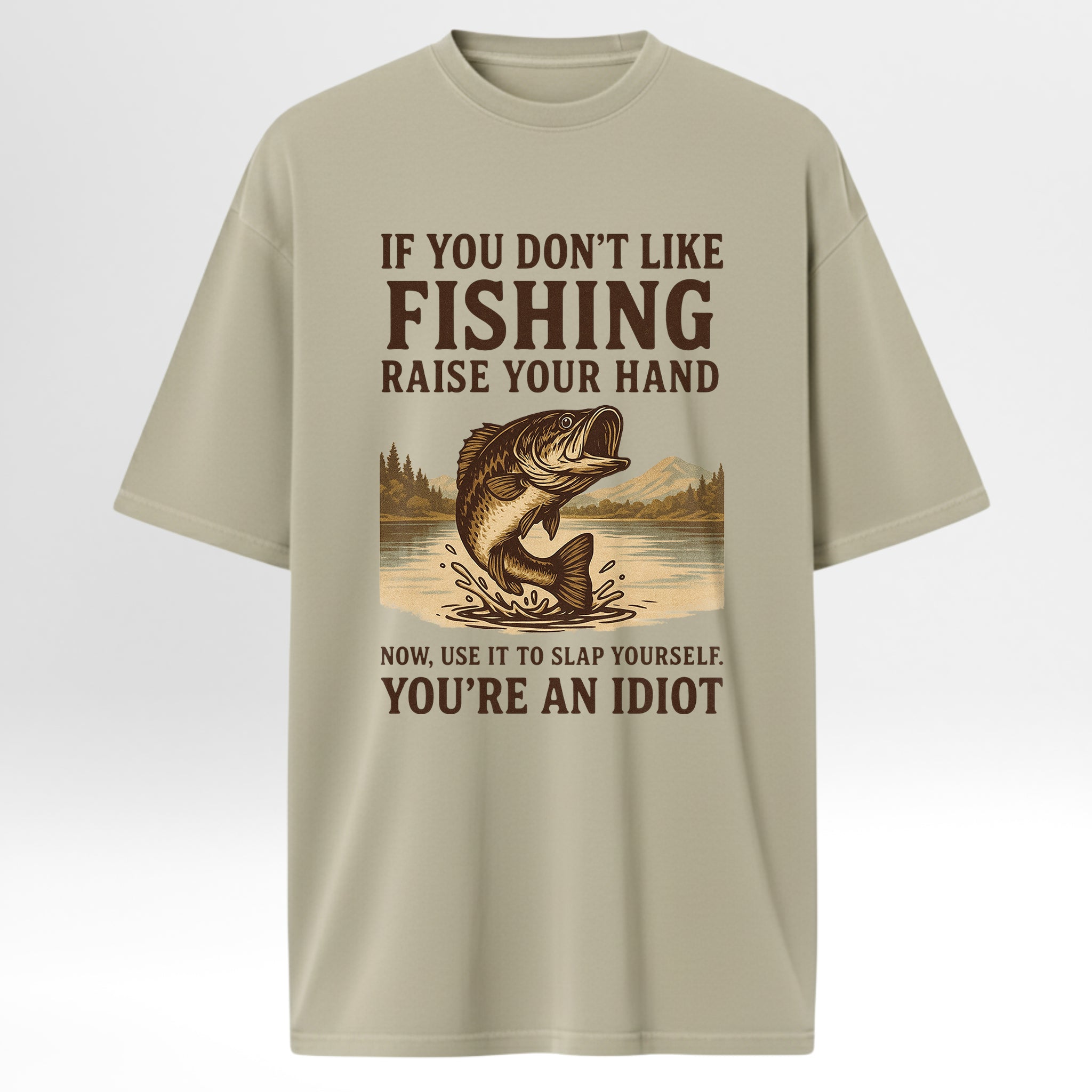 Beige t-shirt with fishing graphic and humorous 'If You Don't Like Fishing Raise Your Hand Now Use It To Slap Yourself You're An Idiot'