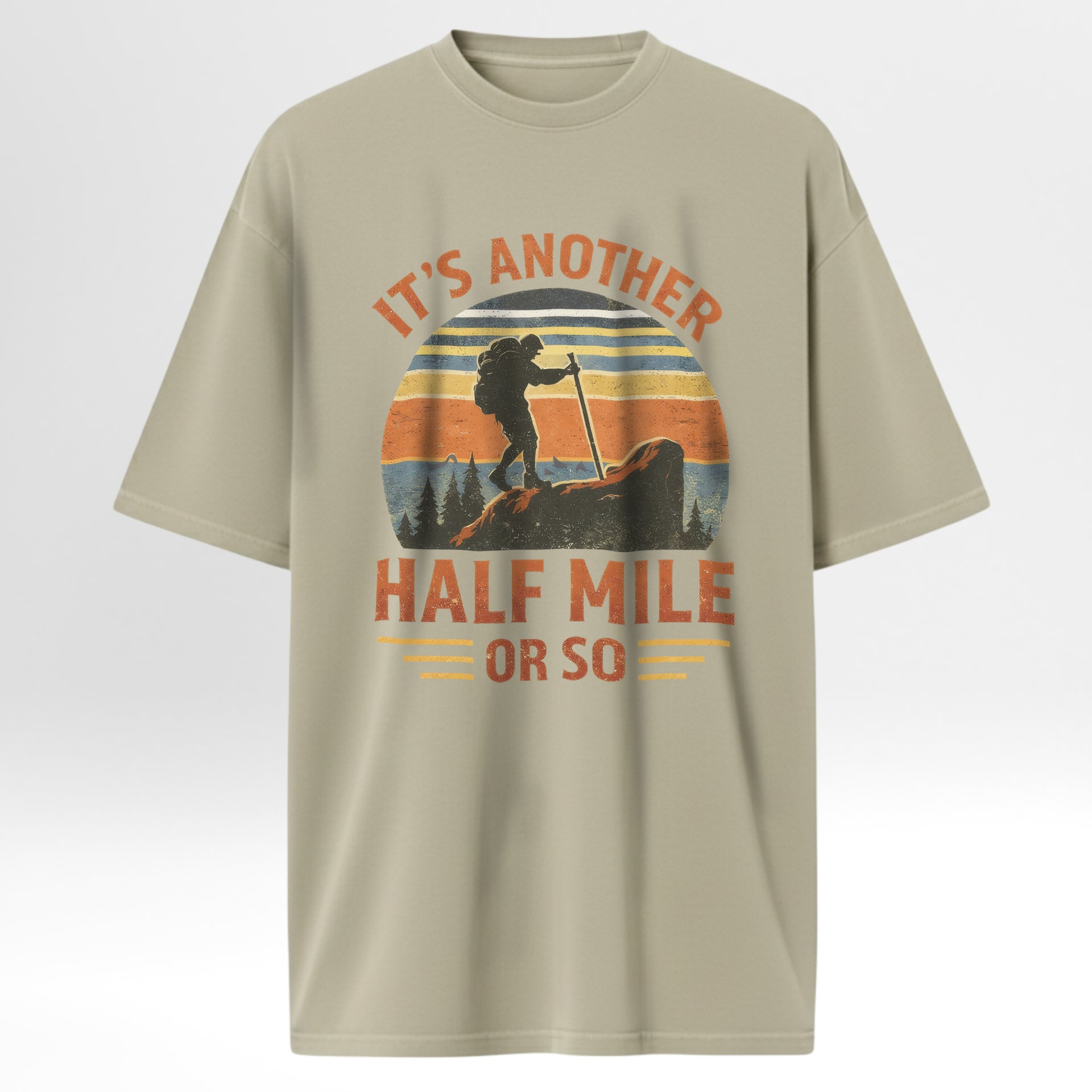 Beige outdoor t-shirt with a graphic design of a hiker and text 'It's Another Half Mile Or So'.