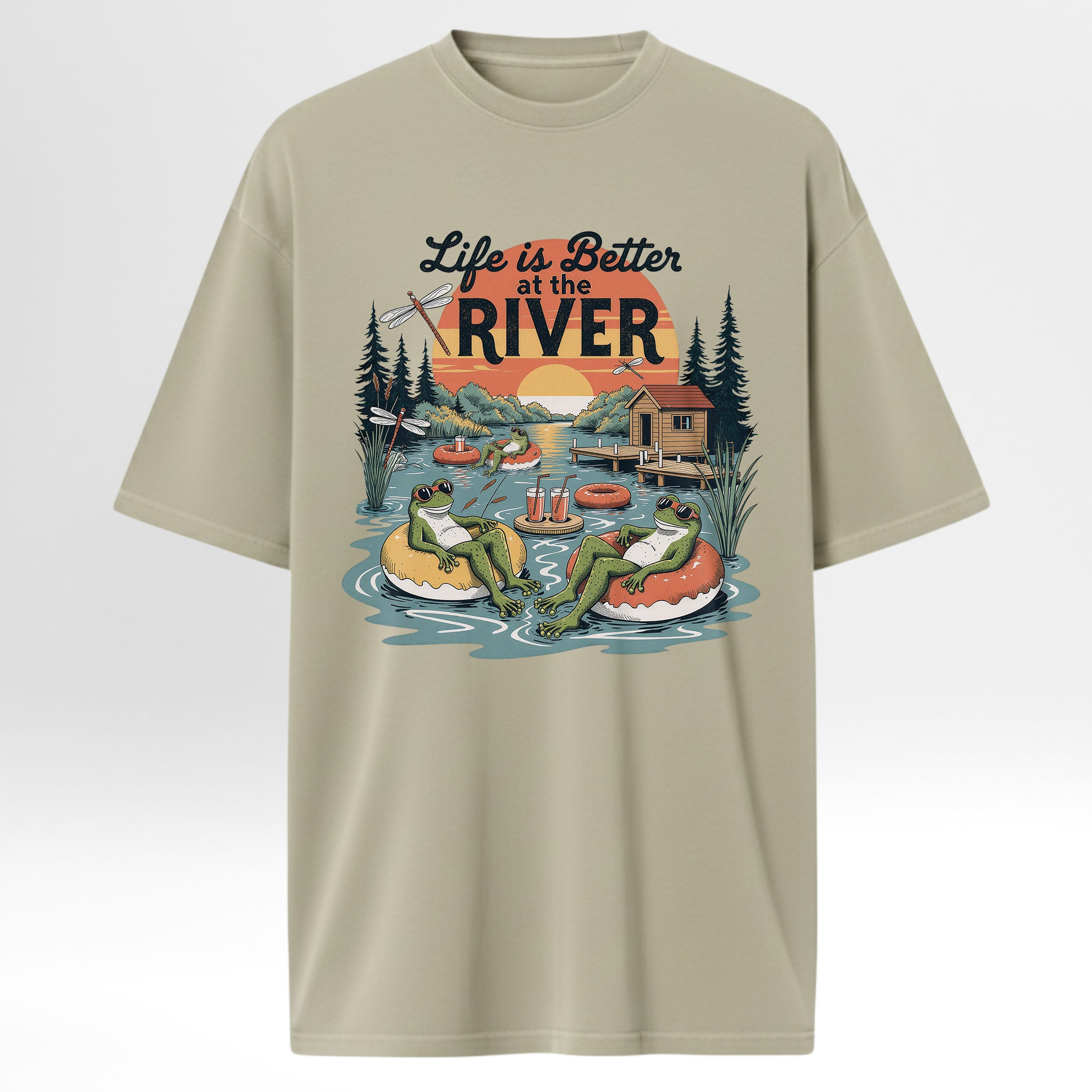 Beige t-shirt with 'Life is Better at the River' graphic design featuring frogs and a cabin.