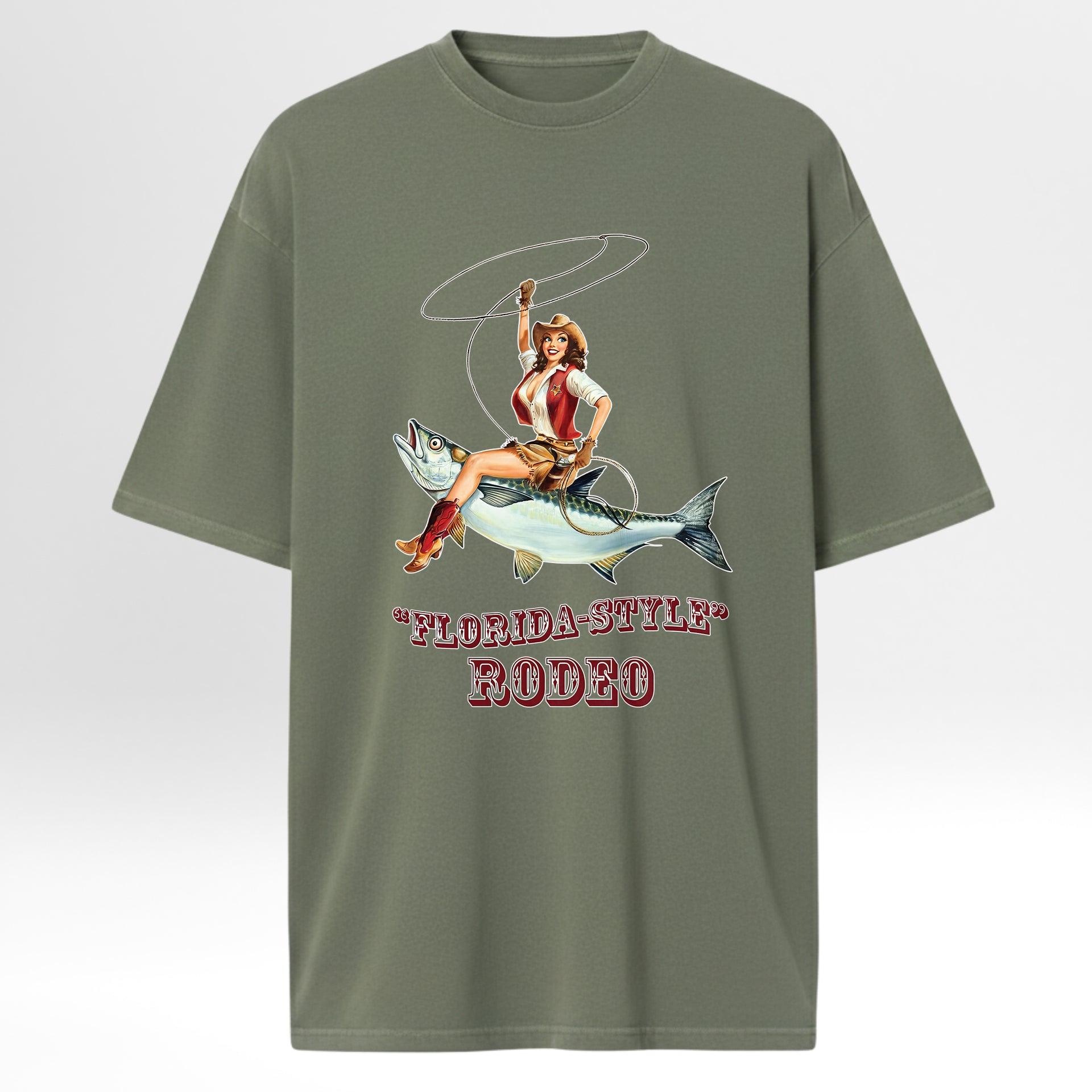 Green fishing graphic t-shirt with a graphic of a woman riding a fish and 'Florida-Style Rodeo' text on a white background