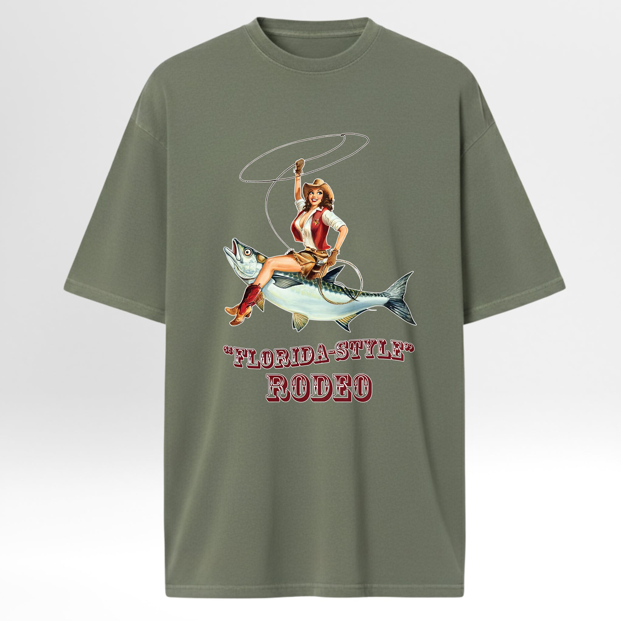 Green fishing graphic t-shirt with a graphic of a woman riding a fish and 'Florida-Style Rodeo' text on a white background