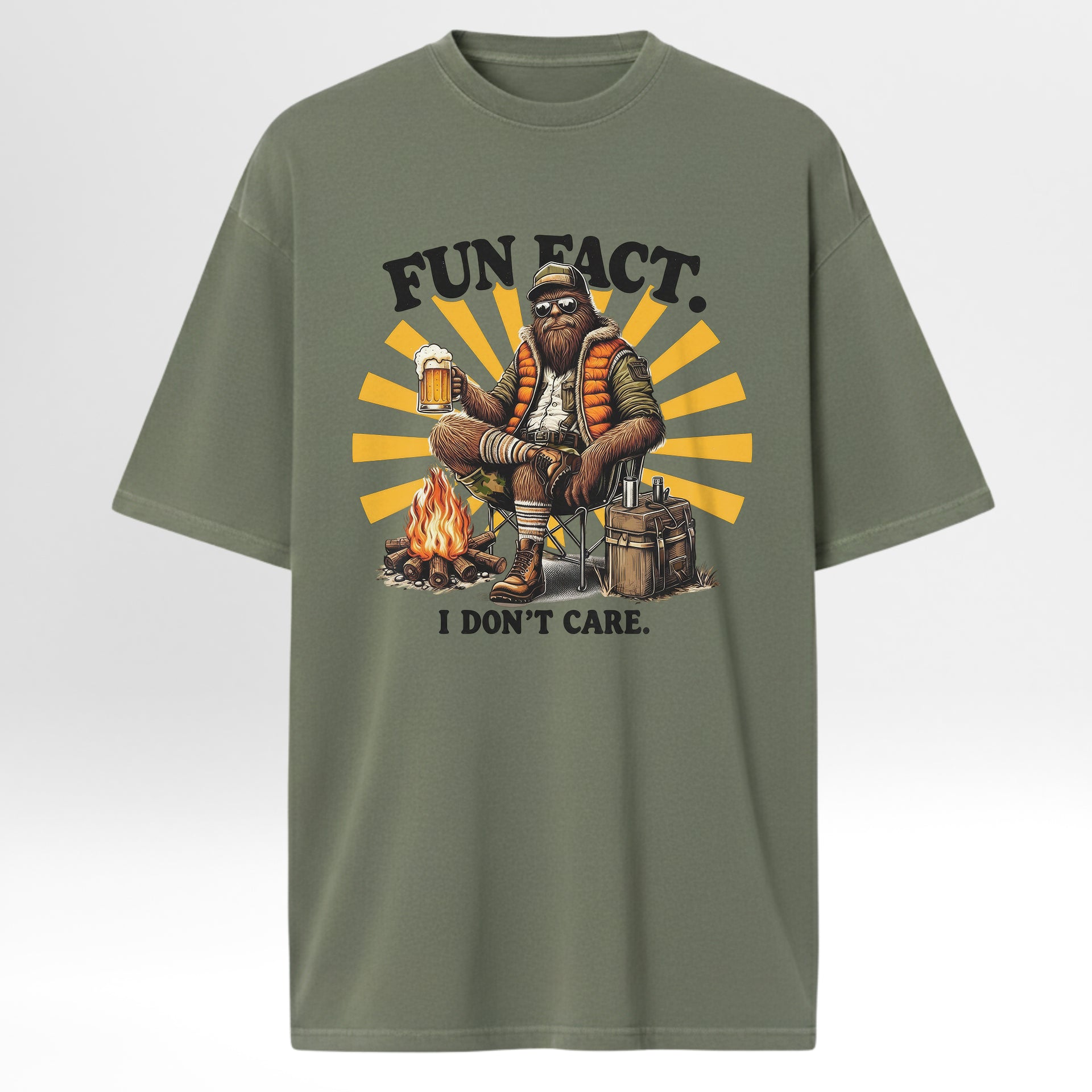 Green camp & trail t-shirt with a graphic of a person by a campfire and text 'FUN FACT. I DON'T CARE.' 