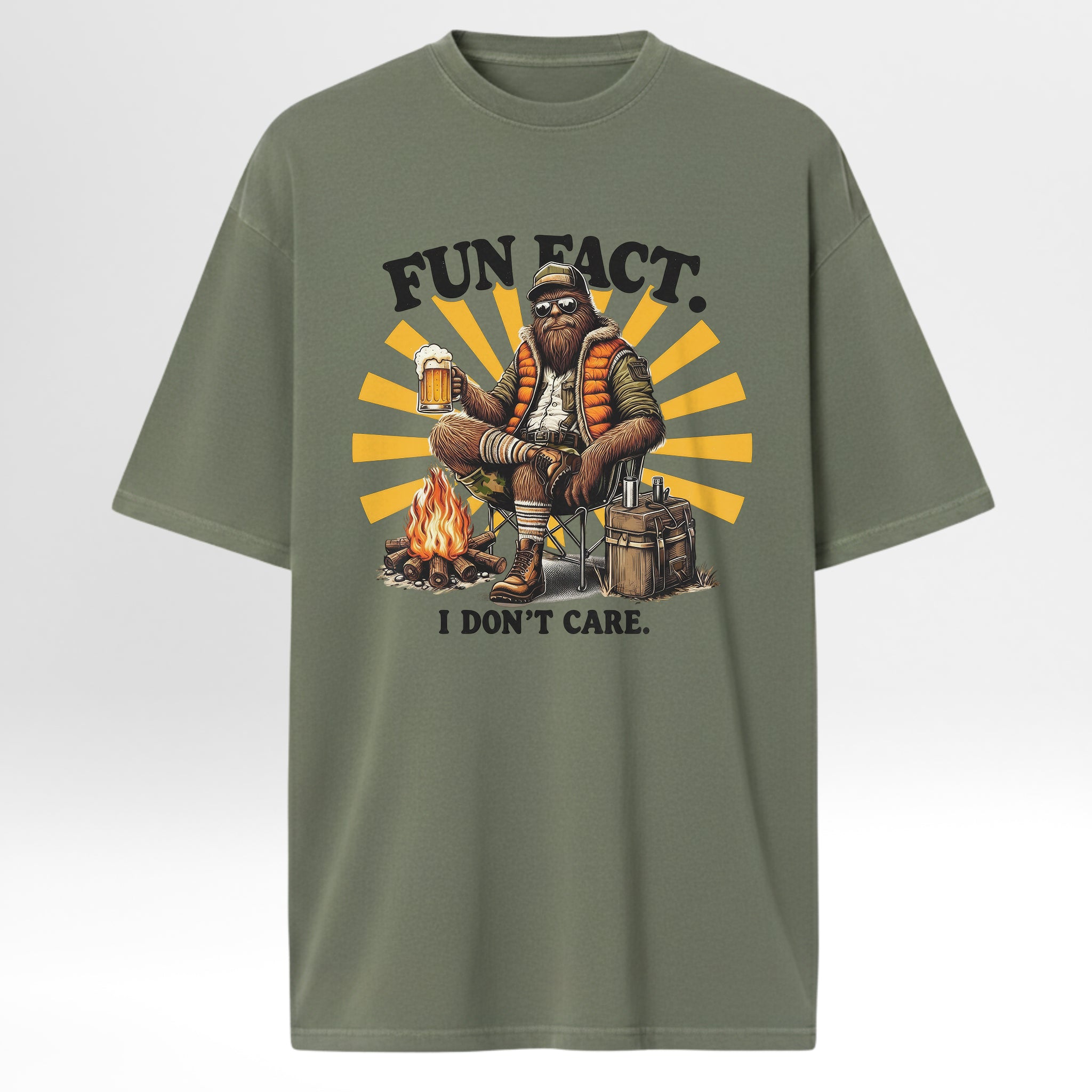 Green camp & trail t-shirt with a graphic of a person by a campfire and text 'FUN FACT. I DON'T CARE.' 