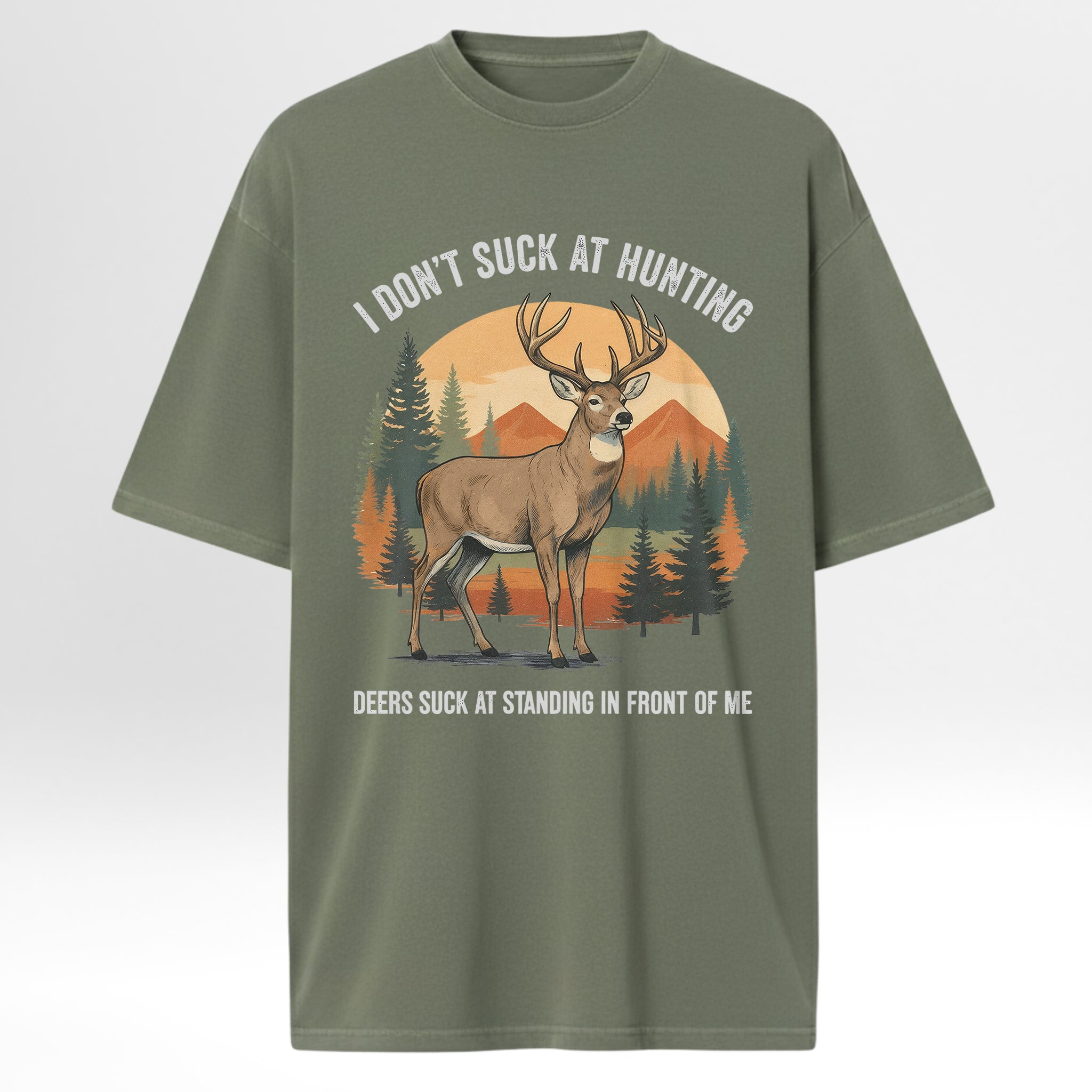 Green hunting t-shirt with a deer graphic and text 'I Don't Suck At Hunting Deers Suck At Standing In Front Of Me'.