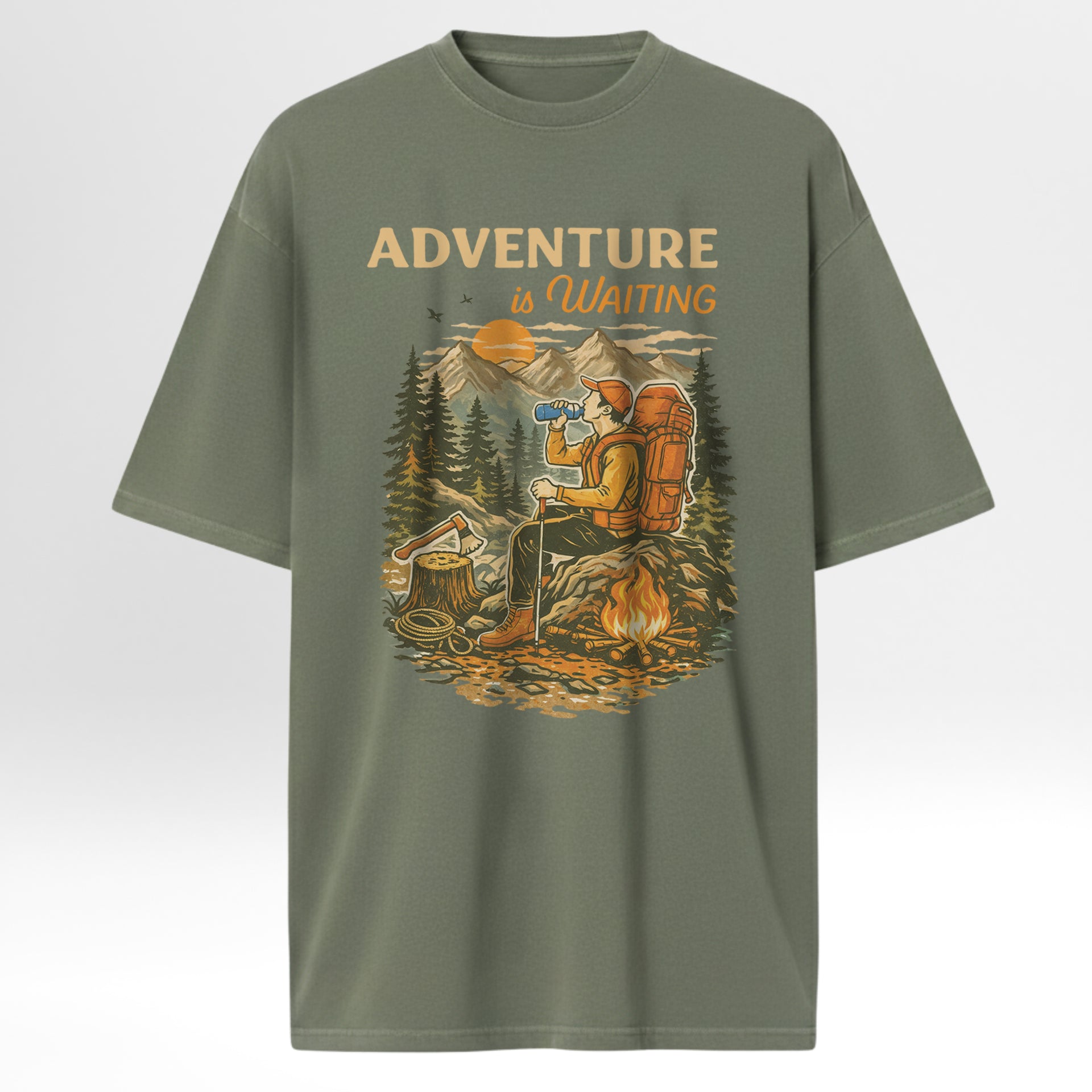 Green t-shirt with a graphic of a person by a campfire and 'Adventure is Waiting' text on a white background