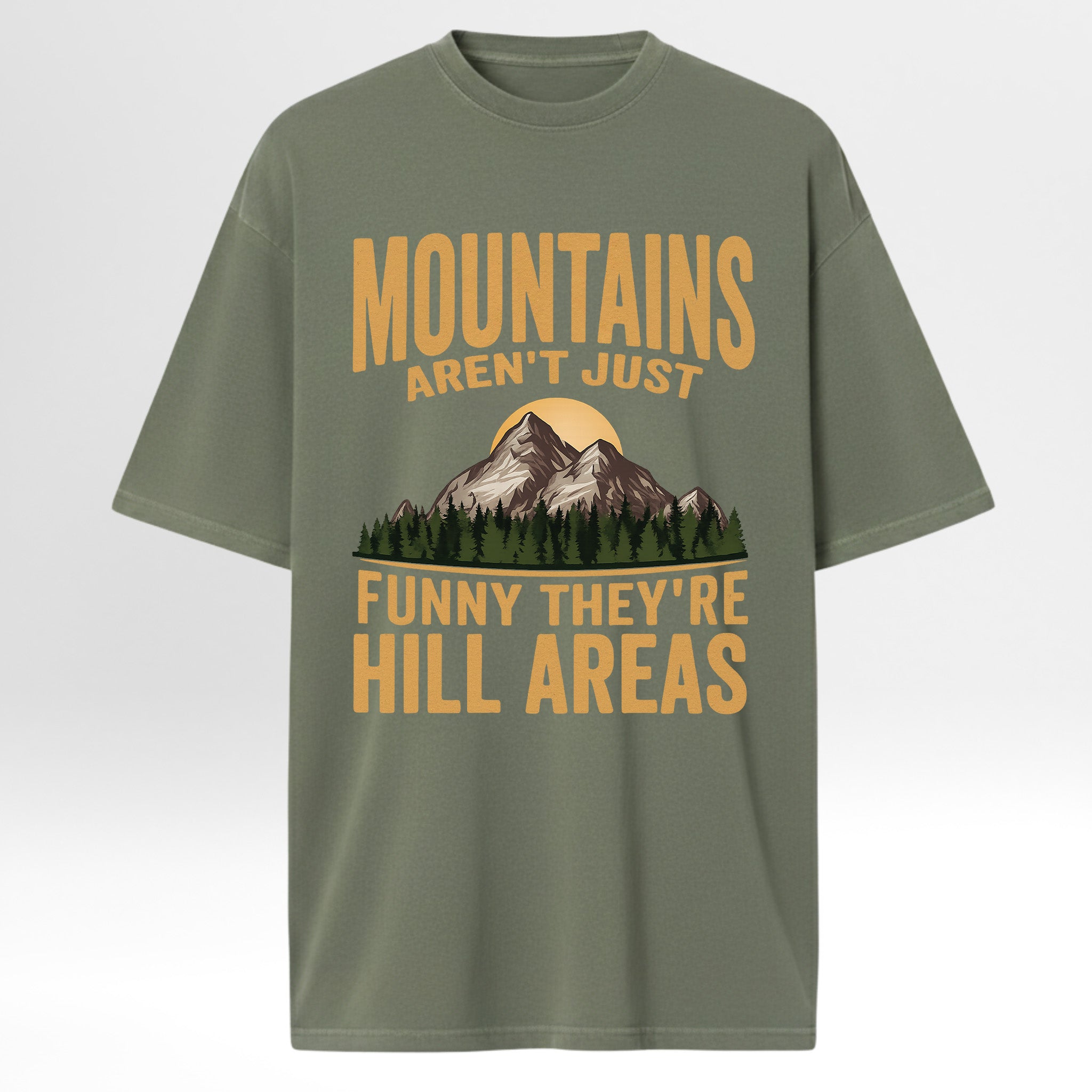 Green t-shirt with mountain graphic and humorous text 'Mountains Aren't Just Funny They 're Hill Areas'