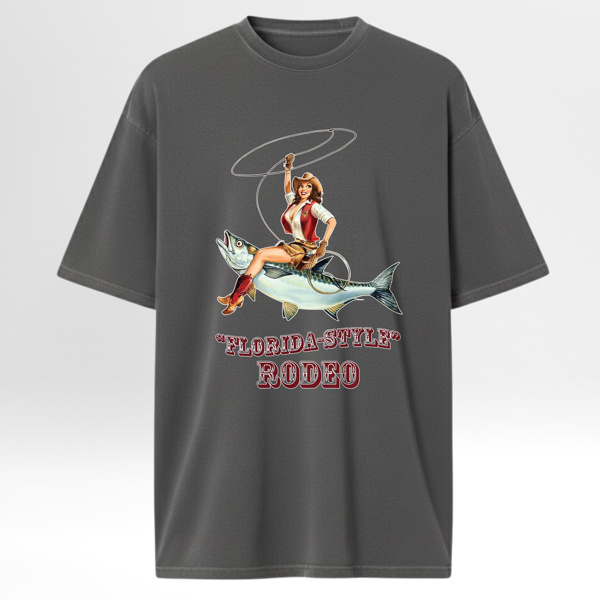 Gray fishing graphic t-shirt with a graphic of a woman riding a fish and 'Florida-Style Rodeo' text on a white background