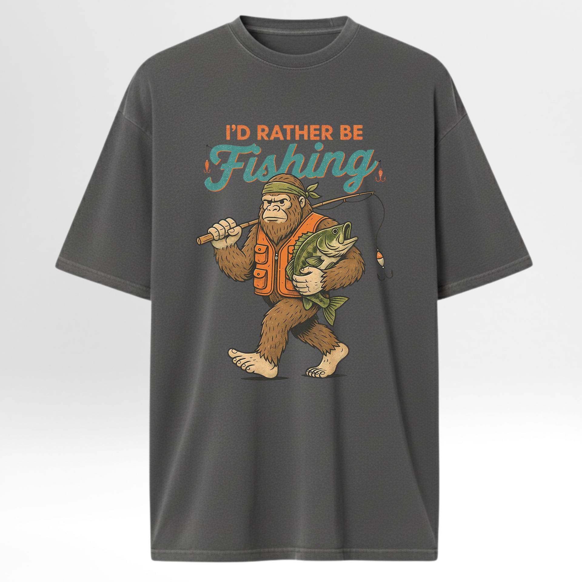 Gray fishing t-shirt with a graphic of a bigfoot holding a fish and a fishing rod, with text 'I'd Rather Be Fishing'.