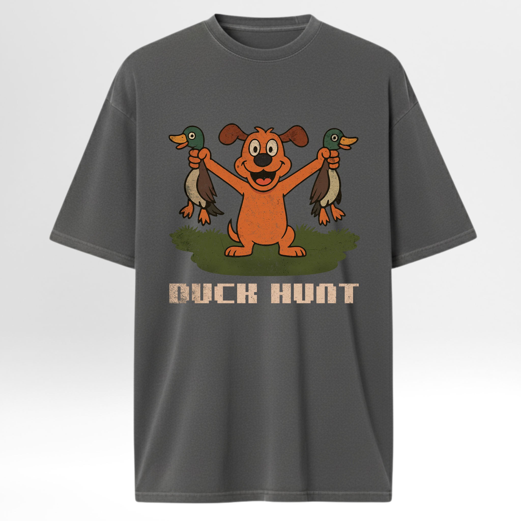 Gray hunting graphic t-shirt with a cartoon dog holding two ducks and 'Duck Hunt' text on a white background