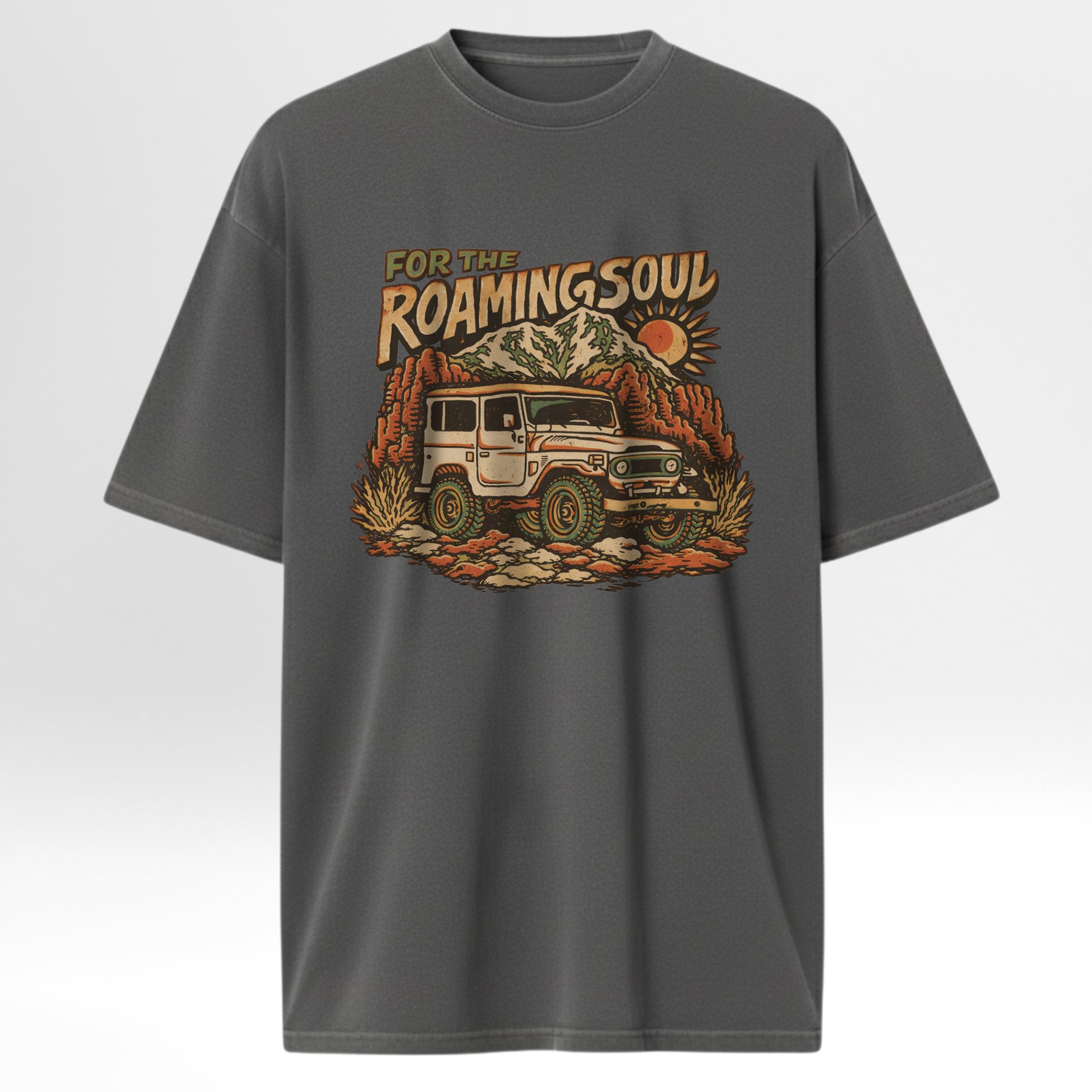 Gray t-shirt with a graphic of a vintage jeep and mountain landscape with text 'For The Roaming Soul'