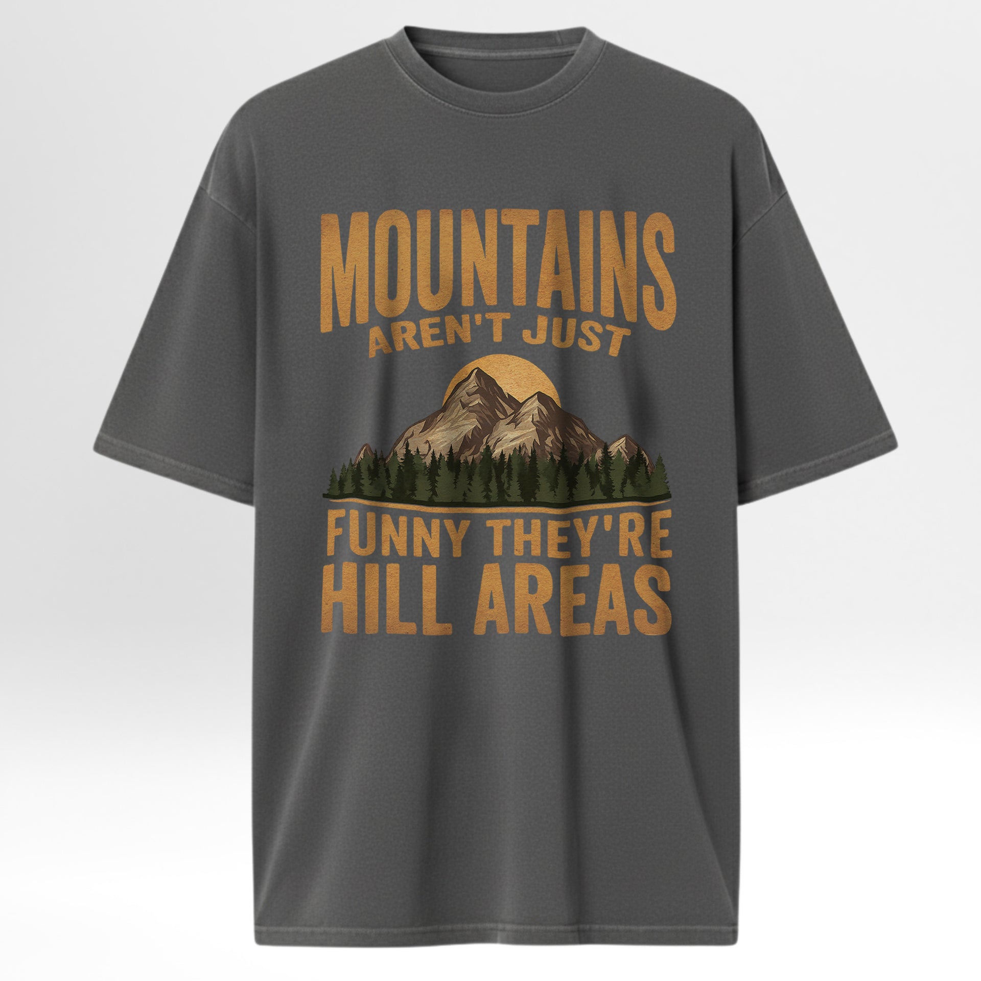Gray t-shirt with mountain graphic and humorous text 'Mountains Aren't Just Funny They're Hill Areas'