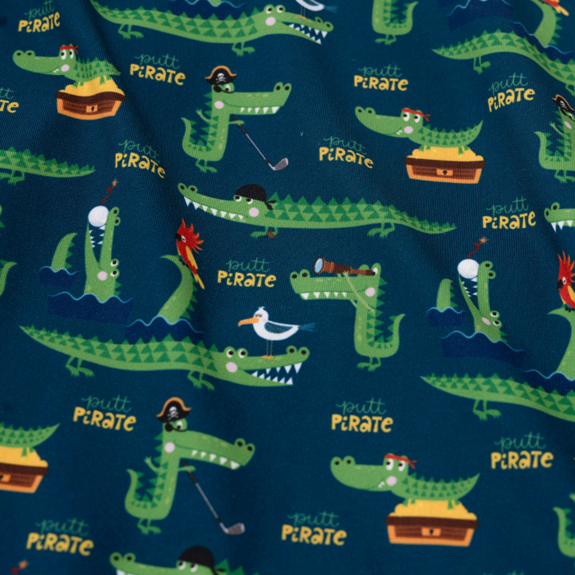 Fabric with pirate-themed alligator pattern on a blue background