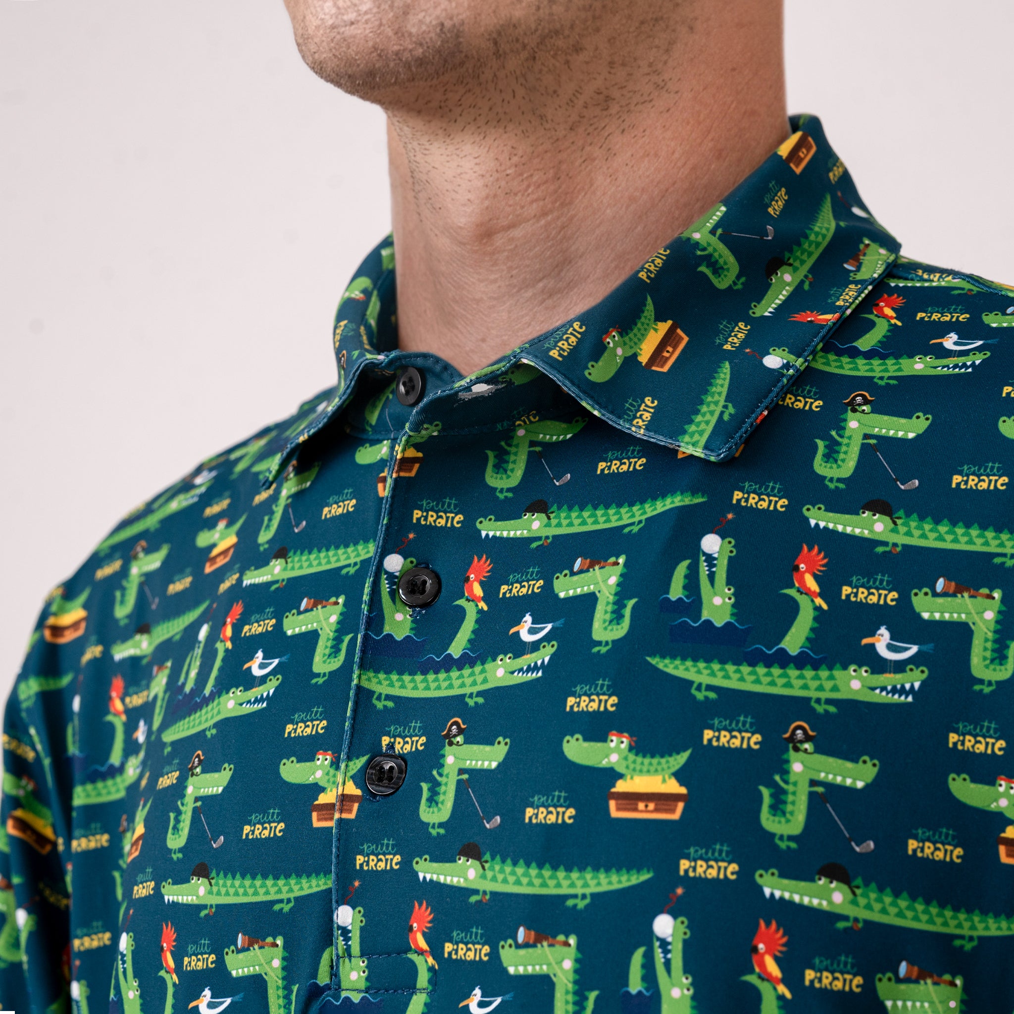 Man wearing a green shirt with pirate-themed alligator print