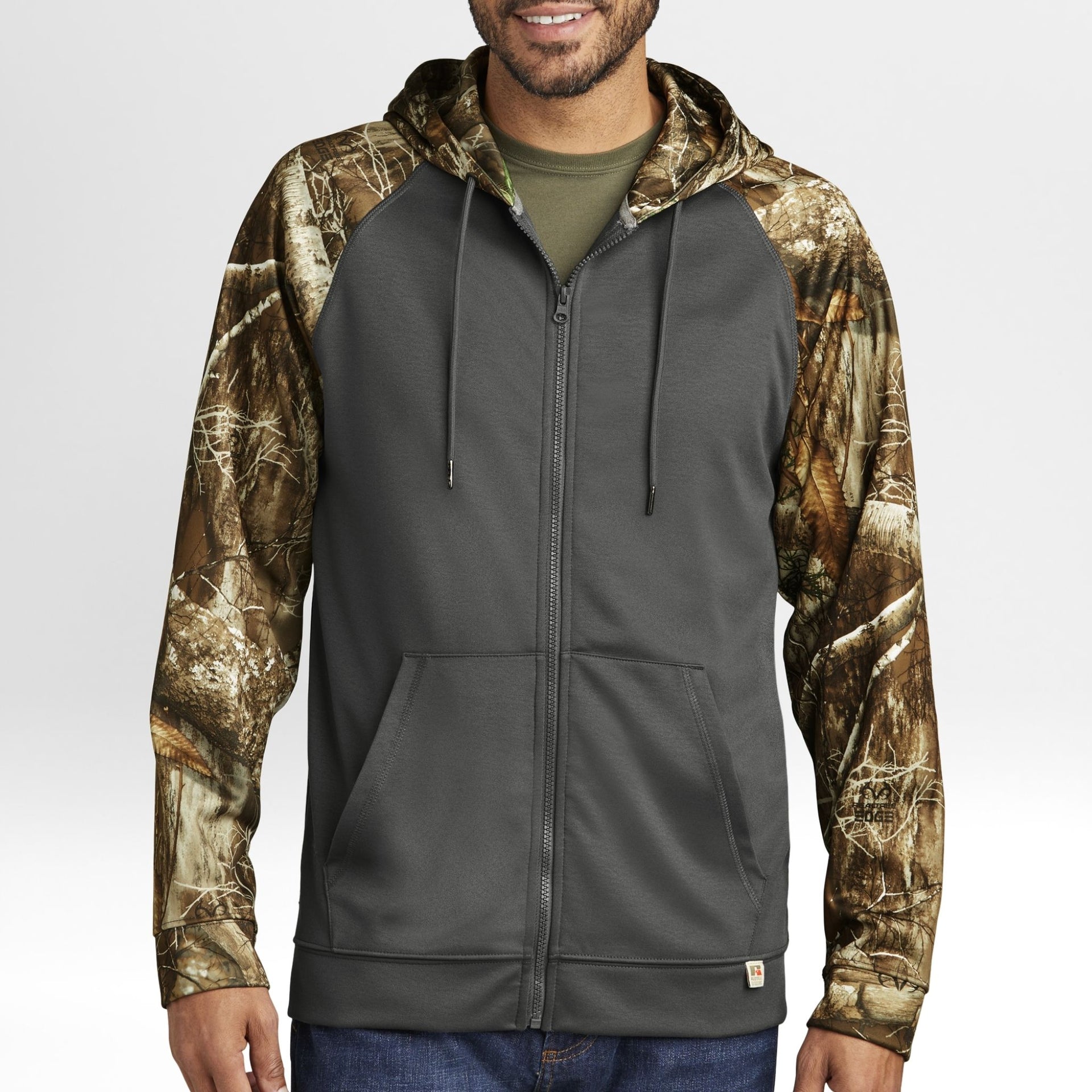 Man wearing a gray hoodie with Realtree Edge camouflage sleeves on a white background