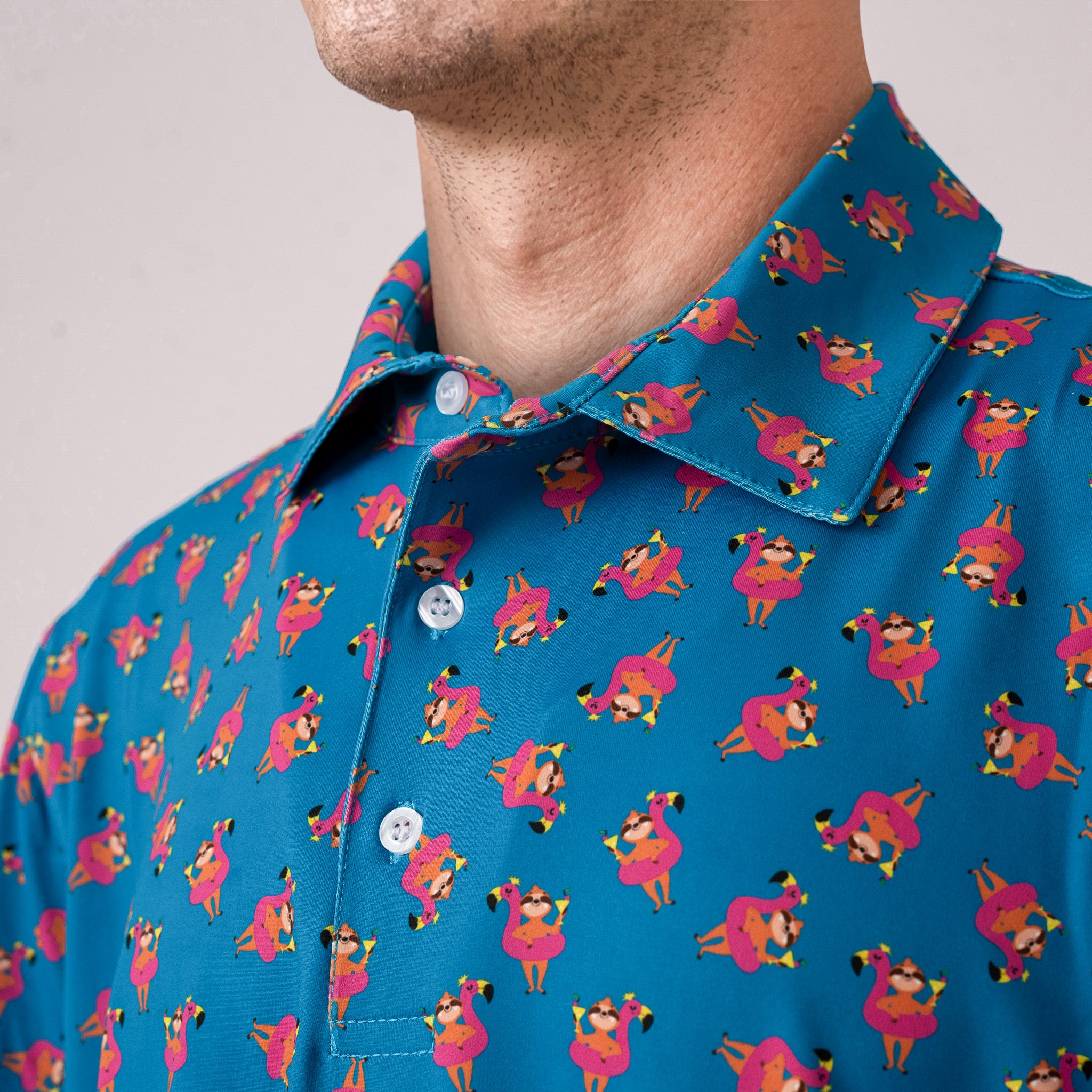 Close-up of a blue shirt with sloth on flamingo float