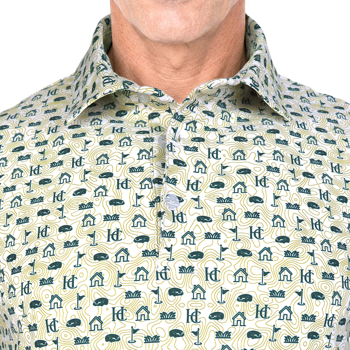 A close-up of a man wearing a polo shirt with a repeating golf-themed print of clubs, balls, flags, and holes on a light cream background.